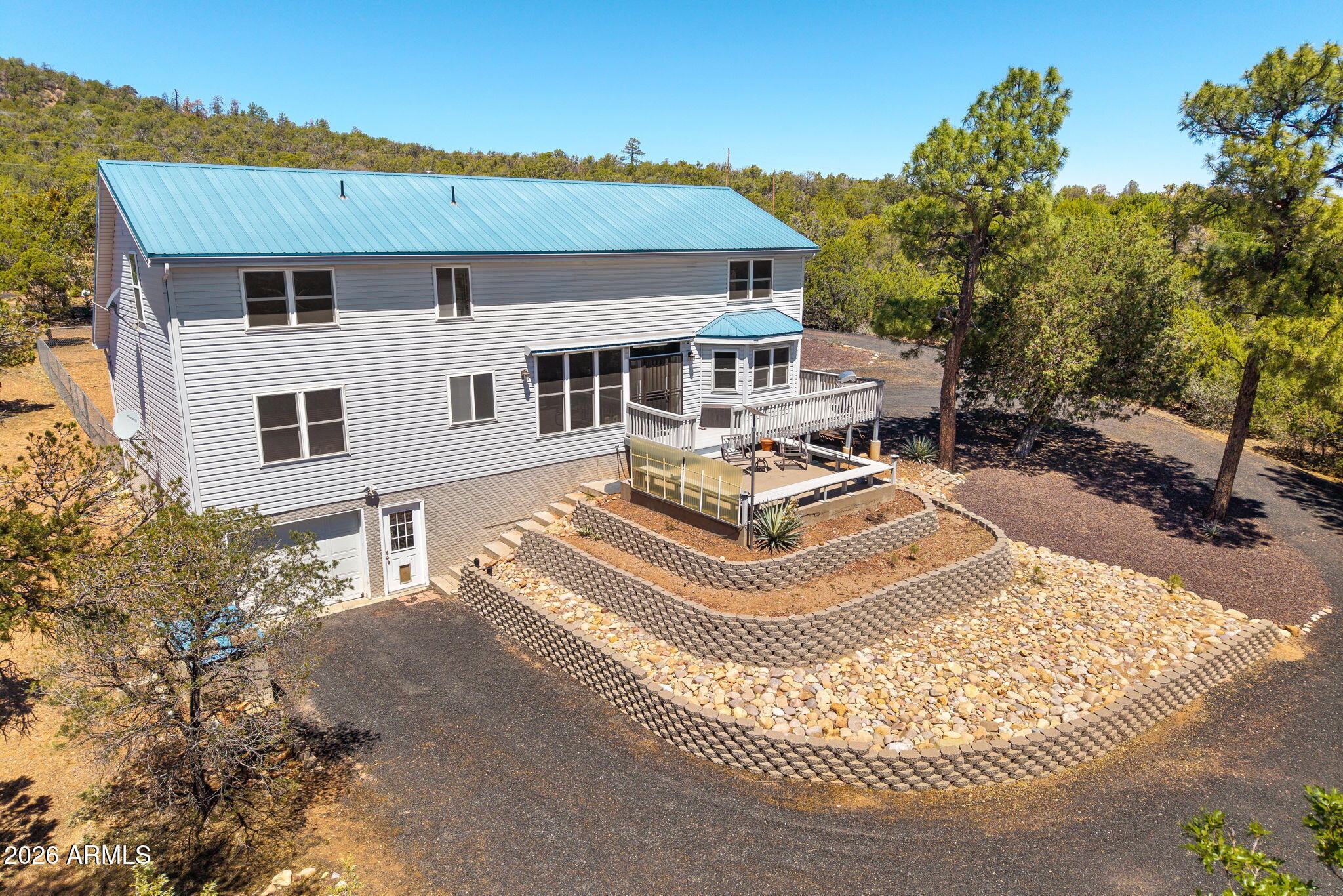 HORSE PROPERTY WITH INCREDIBLE VIEWS IN SHOW LOW, AZ (Linden Area)! Escape to the peaceful mountain lifestyle with this beautifully maintained 4-bedroom, 3.5-bath home on 2.67 acres in the Linden area of Show Low. Surrounded by tall pines with USFS land just across the road, this property offers privacy, panoramic views, and plenty of space for horses, outdoor living, or simply enjoying Arizona's White Mountains. Inside, you'll find over 2,500 square feet with vaulted ceilings, a spacious layout, and an unfinished walk-out basement offering endless possibilities for additional living space, recreation, storage, or a future game room. The home features a warm mountain feel with a wood-burning stove, formal dining area, spacious kitchen, and large windows designed to capture the incredible scenery. Step outside onto the back deck and take in the breathtaking views and fresh mountain air. Additional features include a metal roof, landscaped yard, attached garage, shared well with metered water, and easy access to Show Low while still offering the privacy and serenity buyers are searching for in mountain living. Ideal as a full-time residence, vacation home, or horse property retreat.