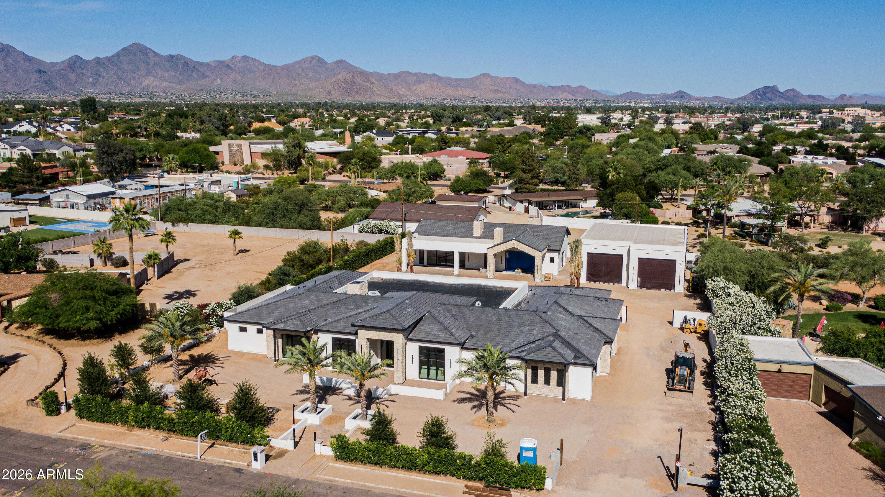 Construction Finishing 5/30/26. This exceptional 8,745 sqft  gated estate in the coveted Cactus Corridor showcases timeless design, refined finishes and seamless indoor-outdoor living.
The main residence features an elevated living experience with a thoughtfully designed floor plan featuring 5 bedrooms, 5.5 bathrooms. A dedicated office, private gym, elegant dining room with climate-controlled wine storage, and a dedicated teen lounge with direct outdoor access.  At the heart of the home, a chef's kitchen appointed with rift white oak cabinetry, dual islands, premium quartzite surfaces, Wolf and Subzero appliances, Miele coffee bar, and full-service butler's pantry.  A separate guest suite, with double vanities and private entrance, and three additional ensuite bedrooms, provide comfort.. and privacy, all seamlessly connected to the home's main living spaces. The primary suite is a private retreat, complete with its own coffee bar and fireplace, a spa-inspired bath with steam shower, dual water closets, and a thoroughly built out, custom walk-in closet featuring a washer and dryer, make-up vanity, and integrated soft LED-lit cabinetry.
Also featuring a 2,527 sqft detached guest house with full kitchen, fireplace, separate bedroom, and laundry.  Attached, a stunning game room, showcases full bar, dramatic stone fireplace, vaulted beamed ceilings, and a glass garage door that opens to an expansive stone patio featuring a private two-way fireplace. 
 
Outdoors living is elevated with a resort-style pool and spa, multiple covered patios, fireplaces, and a fully equipped outdoor bar, all designed for year-round enjoyment.  The double RV garage is a standout feature, offering a fully climate-controlled environment, 50-amp hookup, separate workshop area, mezzanine storage, glass garage doors, ideal for motorhome, car collection, indoor sport court, or golf simulator.  
A rare opportunity to own a truly distinguished estate in one of the area's most desirable locations.