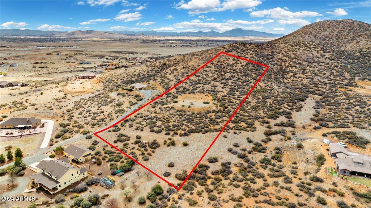 *** Capture Breathtaking Panoramic views of Woodchute &  Mingus Mountains from this Rare Hillside  6 Acre homesite in Coyote Crest with Well already In !   Breath in  crisp Mountain Air nestled a top the valley range, surrounded by beautiful views  from this elevated  homesite  in a gated community.  Conveniently Located on paved roads with  secluded out in the country feel,  yet near  all the amenities  in nearby Prescott Valley / Prescott.  Quick access to scenic 89A over Mingus Mtn to visit / explore Jerome, Cottonwood, Sedona !  Lot Improvements include:  Build Pad, Electricity & Well all in !    Ready  to build  your dream home / retreat ! Experience the tranquility of country living yet near modern conveniences. Million $+  Homes in Coyote Crest ! Ask for  Access to property