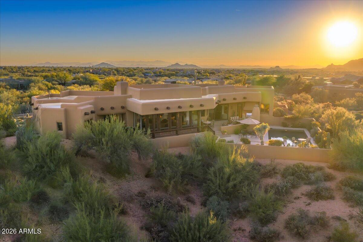 GOLF MEMBERSHIP AVAILABLE. Single-level Southwest-style residence on an elevated 1.5 acre lot on the 18th fairway of the Renegade Golf Course with expansive golf course, mountain & sunset views. Functional floorplan with large floor-to-ceiling windows in living room that capture massive mountain views and natural light. Cozy but spacious family room off kitchen with fireplace. Upgraded kitchen with Wolf & SubZero appliances. Home features 3BRs & 4.5BAs with a large island kitchen, Brazilian granite counters, custom cabinetry & wood floors. Spacious primary suite has his & hers full bathrooms & closets. Very private setting with pool, spa & mature desert landscaping. A rare fairway property combining a full golf membership, acreage, elevation & single-level living in North Scottsdale. New roof, recently painted inside & out. See documents for upgrades & updates. Furnishings available by separate bill of sale. 2 of the 4.5
Baths are in the Primary Suite.