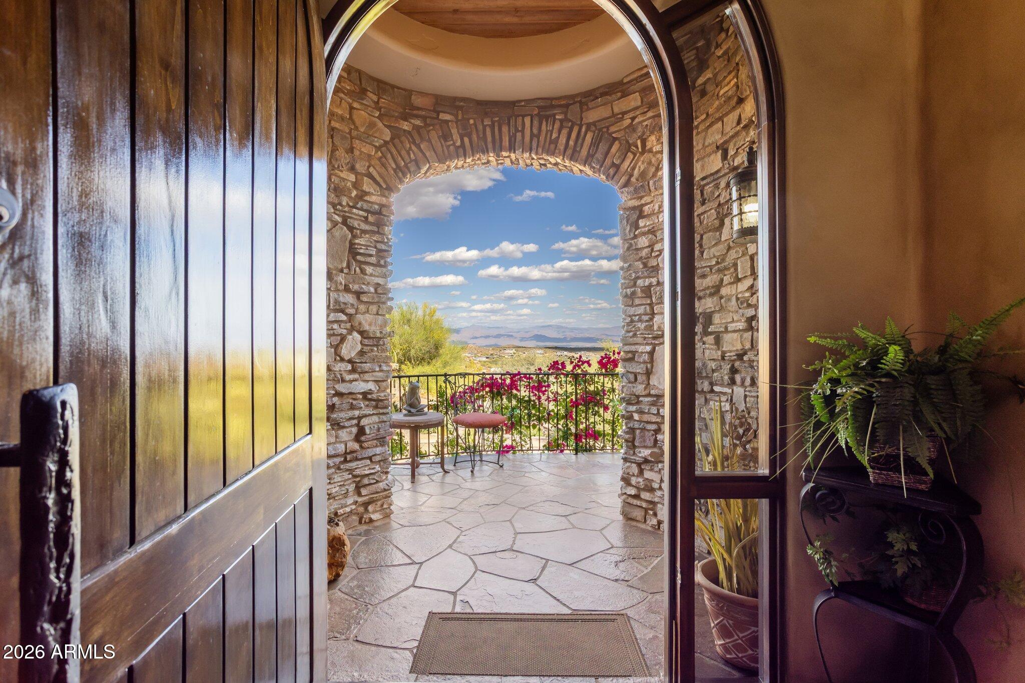 Seller is open to all offers! Unmatched views. Irreplaceable setting. A rare opportunity! Perched on a private hillside in Scottsdale's Troon Village with commanding vistas of Troon Mountain and the Four Peaks, this home delivers a level of luxury and exclusivity that is simply not being replicated at this price point. Spanning 5,500+ square feet, this Italian-inspired estate was built for those who demand both sophistication and presence. Expansive living spaces, soaring ceilings, and walls of glass frame breathtaking desert views--creating a daily experience that feels like a private resort. The kitchen and great room were designed to impress, flowing effortlessly into a full bar and entertainment space ideal for hosting at any scale. Disappearing glass doors open to a backyard that rivals five-star resorts--complete with a heated pool and spa, dramatic rock waterfall, outdoor fireplace, and built-in BBQ. This is Arizona living at its absolute peak. The split floor plan offers privacy and flexibility, anchored by a luxurious primary retreat with dual closets and a private fitness space. Ensuite guest rooms, a dedicated executive office, home theater, and a 500+ bottle wine room elevate this home into a true entertainer's estate. With an elevator, climate-controlled garage, and recent system upgrades already completed, this home delivers both convenience and peace of mind--making it ideal as a full-time residence or lock-and-leave luxury escape. Homes with this combination of views, privacy, scale, and upgrades in Troon are exceptionally limited.