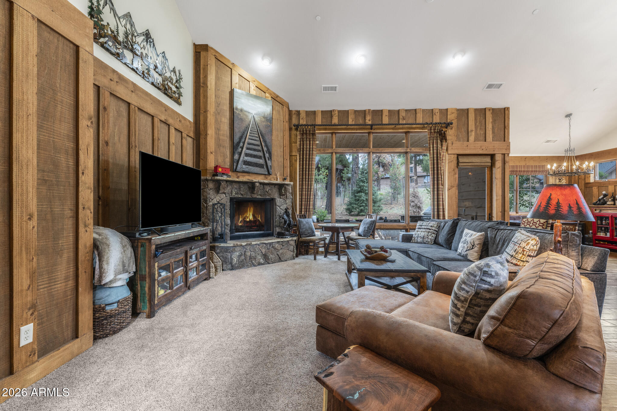Nestled within the sought-after Deer Creek neighborhood, this charming cabin is ideally positioned on a quiet cul-de-sac lot, offering convenient access to the Clubhouse and Pine Canyon's premier amenities. Thoughtfully designed for both comfort and mountain living, the main level welcomes you with expansive windows that fill the great room with natural light, while a stunning Flagstaff-native stone fireplace creates a warm focal point for gathering and relaxing. Rich wood flooring throughout the main level, paired with natural wood siding accents in the great room and primary suite, enhances the home's inviting mountain-lodge feel. The kitchen is well-appointed with granite countertops, stainless steel appliances, and a spacious island with bar seating, perfect for entertaining or casual dining.
The home features three private en-suite bedrooms, each with dual vanities, including two conveniently located on the main level and an additional guest suite upstairs. The primary suite offers a peaceful retreat with direct access to the patio, complete with a built-in BBQ--ideal for enjoying cool mountain evenings and seamless indoor-outdoor living.
*Home is currently in the rental program and a minimum of 24 hours' notice is required for all showings.*