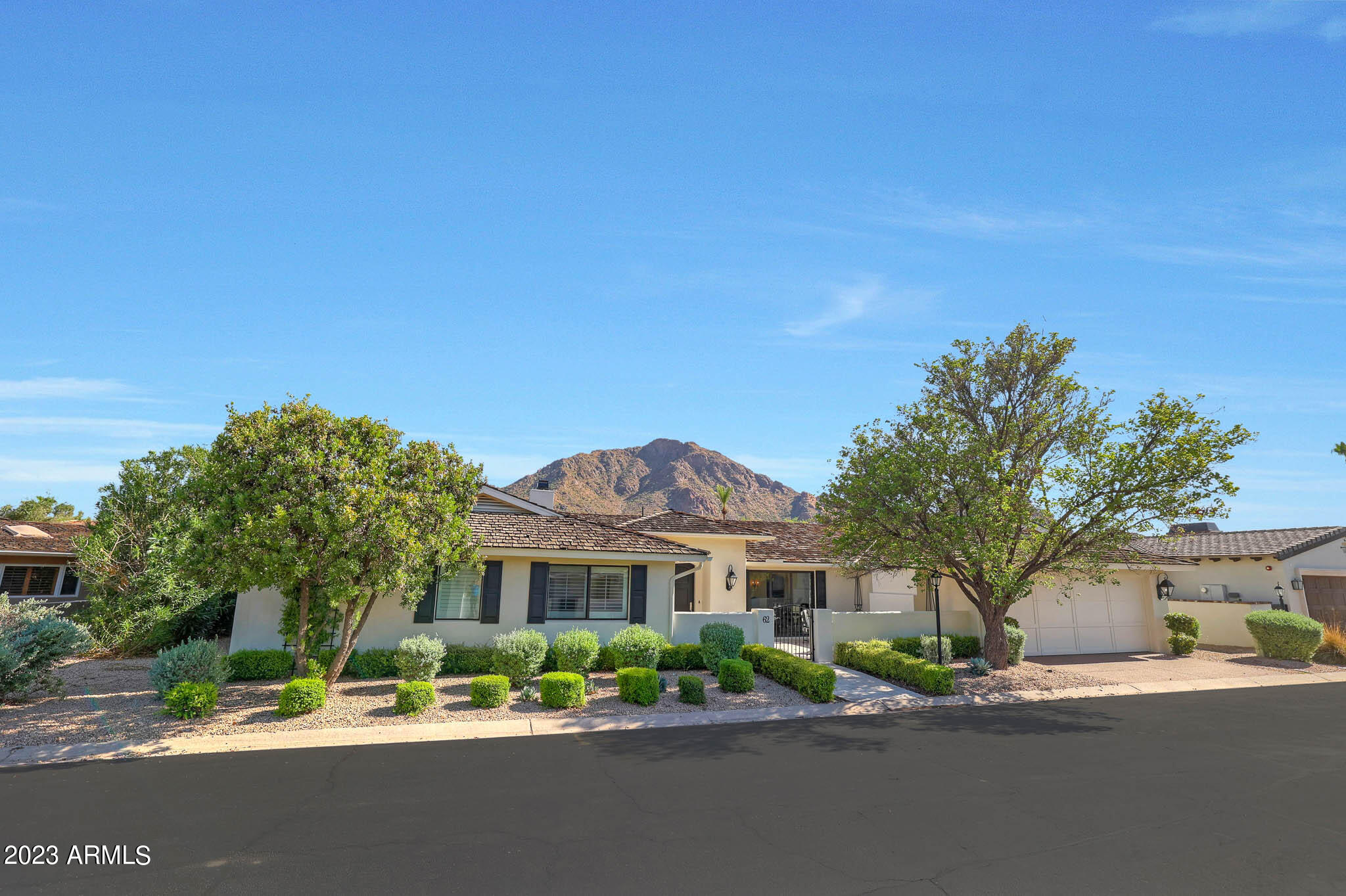 Exceptional location in Mountain Shadows East.  Beautifully renovated 3 bedroom/3.5 bath home + an office on a generous north/south lot backing to open space (currently being renovated by the MS HOA) and boasting STUNNING head to tail Camelback Mountain views! Rarely does a view home like this come to market in here and this 3157 sf home exudes the perfect amount of charm and character.  Spacious en-suite bedrooms split from the beautiful primary suite that features a gas fireplace, fully built out walk in closet, dual sinks, built in vanity and gorgeous mountain views. Oversized covered patio for the ultimate in entertaining... enjoy the built in BBQ, newly installed artificial turf and spacious built in spa all while enjoying the majesty of our famed icon - Camelback Mountain! Additional finishes include a chef's kitchen with a fabulous suite of high end appliances including 48" gas range, 36" Thermador refrigerator and built in ice maker all with quartz countertops and full height backsplash. Beautiful custom cabinetry with separate built in for storage, separate coffee bar and a separate beverage station with glass shelving and wine and drink refrigerators. So many extras and so much to see in this beautiful Mountain Shadows home.