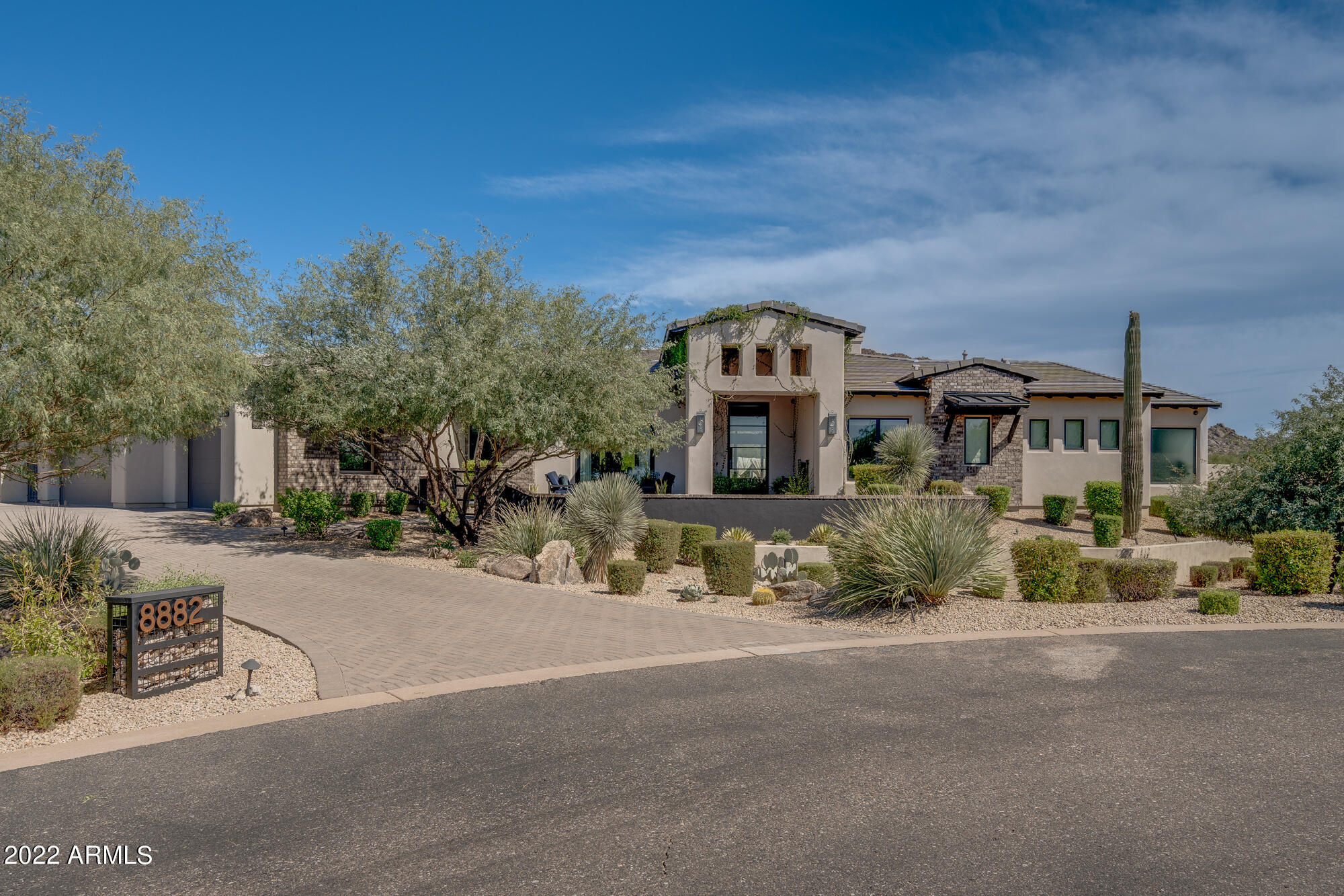 Situated on 1.3 acres with stunning Pinnacle Peak mtn views this custom estate will take your breath away. The moment you enter the front courtyard thru the 10' custom steel entry door you will feel at home.  The Great Room floor plan opens to the backyard via a fully motorized pocket door that disappears into the wall. The chef's kitchen includes a 48'' Wolf gas range w/ dbl ovens, 48'' Sub-zero side by side fridge, farmhouse sink, lg island, and a pass thru counter w/ motorized garage door to the backyard. A walk-in pantry, wet bar, wine dispenser, wine room, wine display wall, Scottsman(sonic) ice maker & mini fridges. The large master suite includes a free standing tub, his/hers water closets, a bonus room w/a motorized garage door that leads to a back patio. See mor The office/den can be an additional bedroom with its own connecting full bath. The backyard paradise includes a heated pool and spa, motorized pool cover, swim up bar, built-in BBQ, countertop seating, turf, putting green, sport court and outdoor shower. No expense was spared in this stunning custom home. It is truly a place to entertain and enjoy all year round. 

Interior features:
- Wide plank French oak wood flooring through out.
- Large mud/laundry room with built in lockers, sink, plenty of counter space and storage.
- Control 4 smart home automation
- Surround sound
- Security cameras through out controlled via Luma app
- Alarm
- Built in garage cabinets
- Pet room with doggie door that leads outside to a closed and walled turf area for pets.
- Office/den has a closet and access to a full bathroom to make it a bedroom if needed. Great for guests or nursery.
- Theatre room/recreation room has access to a full bathroom to make it an additional bedroom if needed.

Exterior features:
- Backyard paradise with heated pool and spa, motorized pool cover, swim up bar, built-in BBQ, counter top seating, turf, putting green, sport court and outdoor shower.

Low maintenance yard features:
- Turf grass through out backyard

Energy efficiency features:
- R-19 at exterior walls, R-38 at roof, R-11 at bedrooms, bathrooms and laundry
- Windows are dual pane low E advanced Argon gas
- Insulated Cloplay garage doors (1) 18x8ft, (1) 9x8ft
- Variable speed pool pump

Plumbing Features:
-White Toto Toilets with elongated soft close seats
-RO system at kitchen sink
-2 Hot Water Heaters (1) 75 gallon and (1) 50 gallon
-Re-Circulation pump in garage unit

Electrical Features:
-6" recessed cans throughout home

Heating & Air Conditioning Features:
-3 heating and cooling systems (1) 5 ton, (1) 4 ton, (1) 2 ton and Mini Split for added circulation in workout room.

Exterior Door features:
-Custom Colletti steel and glass 4'x10' entry door

Interior Doors and Trim features:
-8' solid interior doors
-5" baseboards throughout
-Alder box beams in family room

Cabinetry features:
-Soft close drawers and doors at all locations

Appliance features:
-Sub Zero refrigerator/freezer 48" Built-In SS
-Wolf all gas range 48" SS
-Custom hood 48"
-15" Scotsman sonic ice maker at wet bar SS
-Danby wine cooler- main house bar SS
-Mini fridge at wet bar -SS