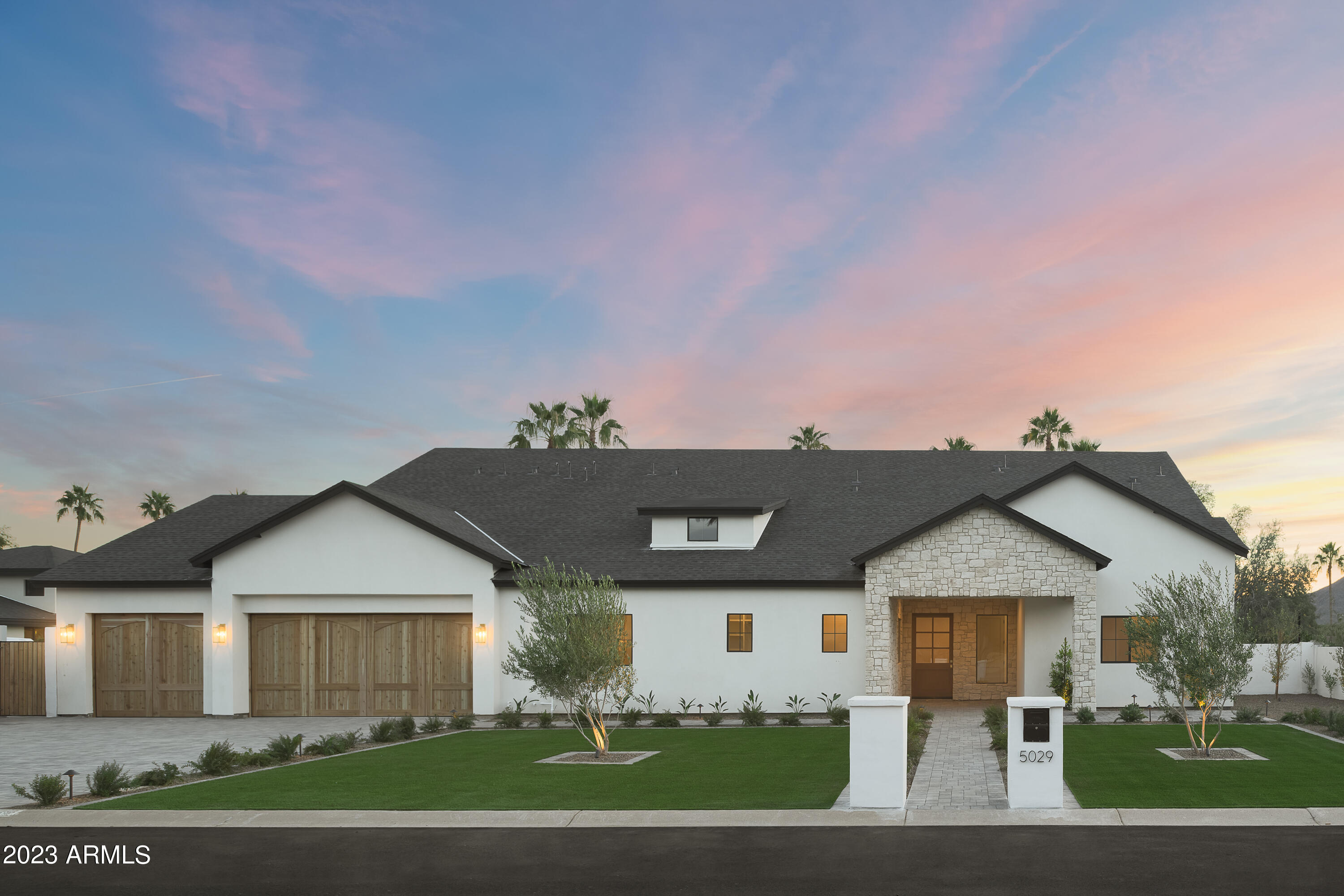 Welcome to this brand new Travis Custom Homes built residence with a stunning desert organic vibe. From the moment you step foot in this beautifully designed home you can feel the warmth and earthy depth of the design brought forth by Kozi Designs. The great room, adorned with a 16' peak takes in an abundance of light from the dual sets of 4 panel pocket doors leading to a massive covered patio. The kitchen is designed with a large lime washed hood with the backdrop of an entire wall of curated stone as the backsplash. The entertainer's dream includes 2 massive islands, 2 sinks, dual dishwashers and separate fridge and freezer. The split floor plan includes 4 spacious bedrooms, all with their own bathroom and an owners retreat any buyer could dream of. Don't miss out on this one! pool deck, built in bbq, a covered patio that encompasses the entirety of the back of the home and huge lower grass area. You won't want to miss the design aspects of this one!