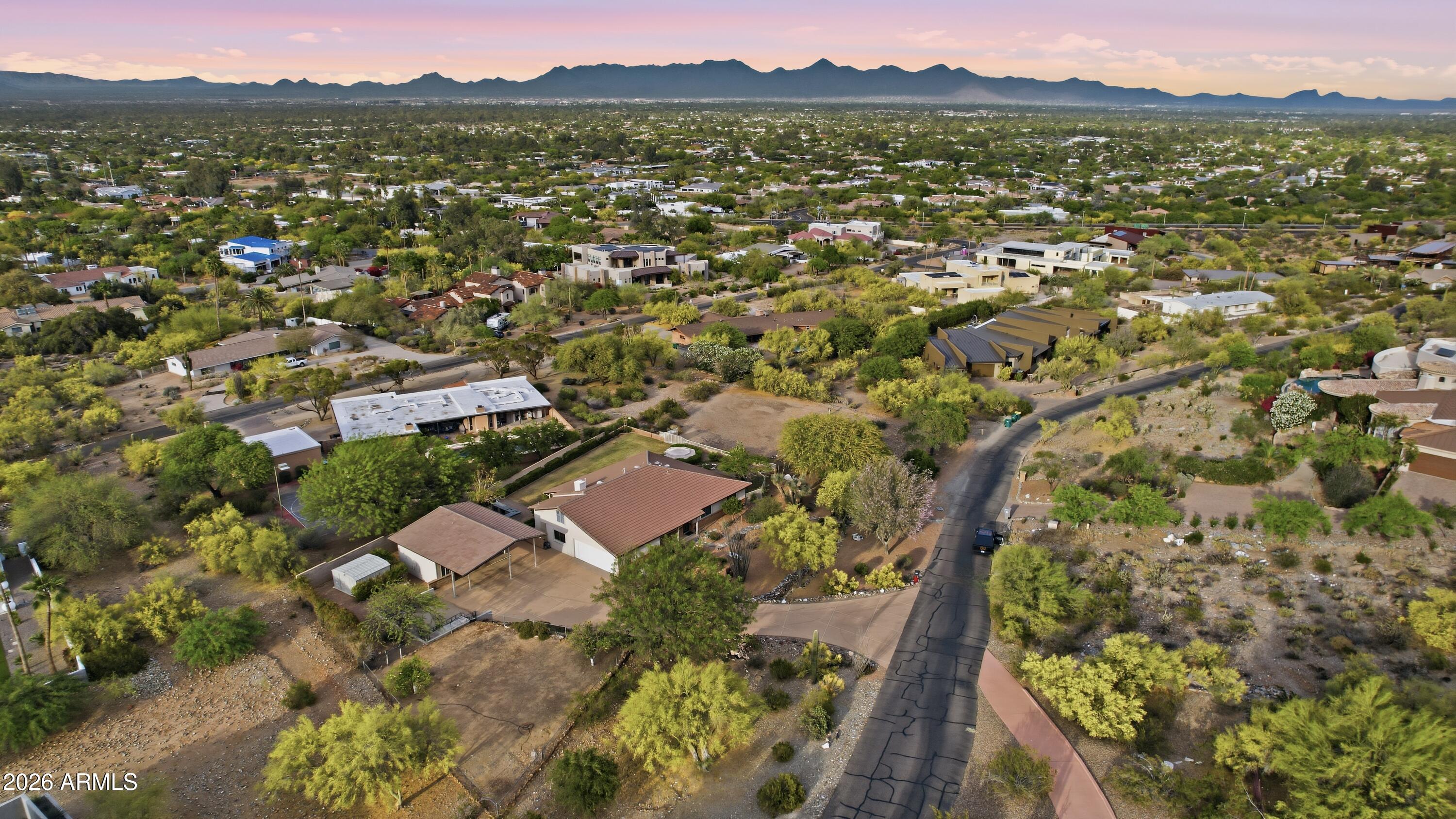 Welcome to one of the most serene parts of Paradise Valley. The property's view corridors to the East, South and West provide breathtaking unobstructed views of mountains & city lights. The limited amount of traffic in the area would be basically those who live in this section of PV. The original block home can be expanded upon for what you envision or the lot itself can be the foundation of your future modern estate. One thing you'll notice is how buildable the site is as it's fairly flat for the elevation. Homes in the area, current and under construction, provide the confidence needed for development as values approach Eight Figures. The N/S oriented lot is desirable as always and the Western Mountains in close proximity provide great late day shade. You'll love the setting! 3C Schools