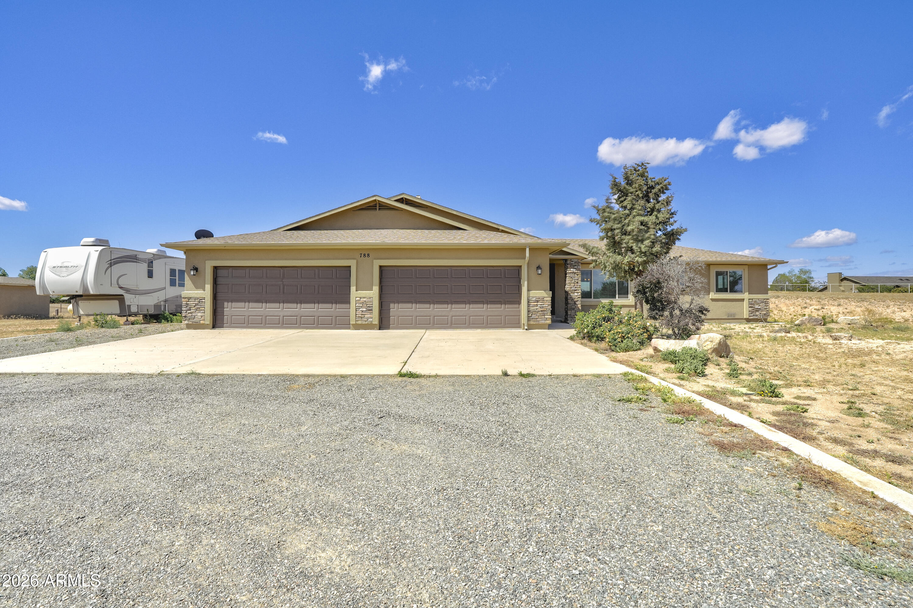 This is the property! 36 GPM well and a single level elegant open floor plan with views of Granite Mountain. Featuring an oversized 4 car garage with epoxy floors, a BRAND NEW Bosch HVAC system, a Rhino Shield exterior paint job, 3 full bathrooms with an en suite, heated floor in the primary bathroom, new carpet in 2 of the bedrooms, and engineered hardwood floors, this property checks all the boxes!  Enjoy the light and bright open floor plan with 10-12 ft ceilings, huge windows taking in the views of Granite Mountain and little Thumb Butte. Stone fireplace, wood burning stove, lots of storage, upgraded lighting, large laundry room. Beautiful kitchen with granite countertops, modern glazed cabinetry, pantry Private patio and spacious lot perfect for horses or toys!