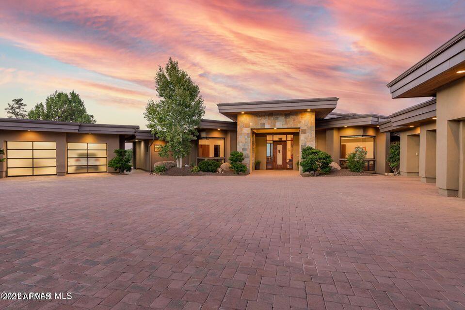 Truly remarkable one of a kind Prescott Compound close to National Forest and a short drive to downtown Prescott. Amazing long distance views from this luxury contemporary masterpiece featuring main home with many upgraded custom features, 1 BR/1Bath Guest Home with its own 2 car garage + custom RV garage with easy access. Situated towards the top of SW Prescott you drive through your own private gate along landscaped tiered planters to a dramatic circular paver driveway with a 4 car and separate 2 car garage. Stunning entry leads to amazing views of Prescott city lights, Granite Mtn and SF Peaks. Main level consists of Master Suite + En Suite + Office, powder room & elevator. Lower level offers En Suite plus Media Room, Game Room & Powder room. Home is situated on 2.94 lush landscaped ...