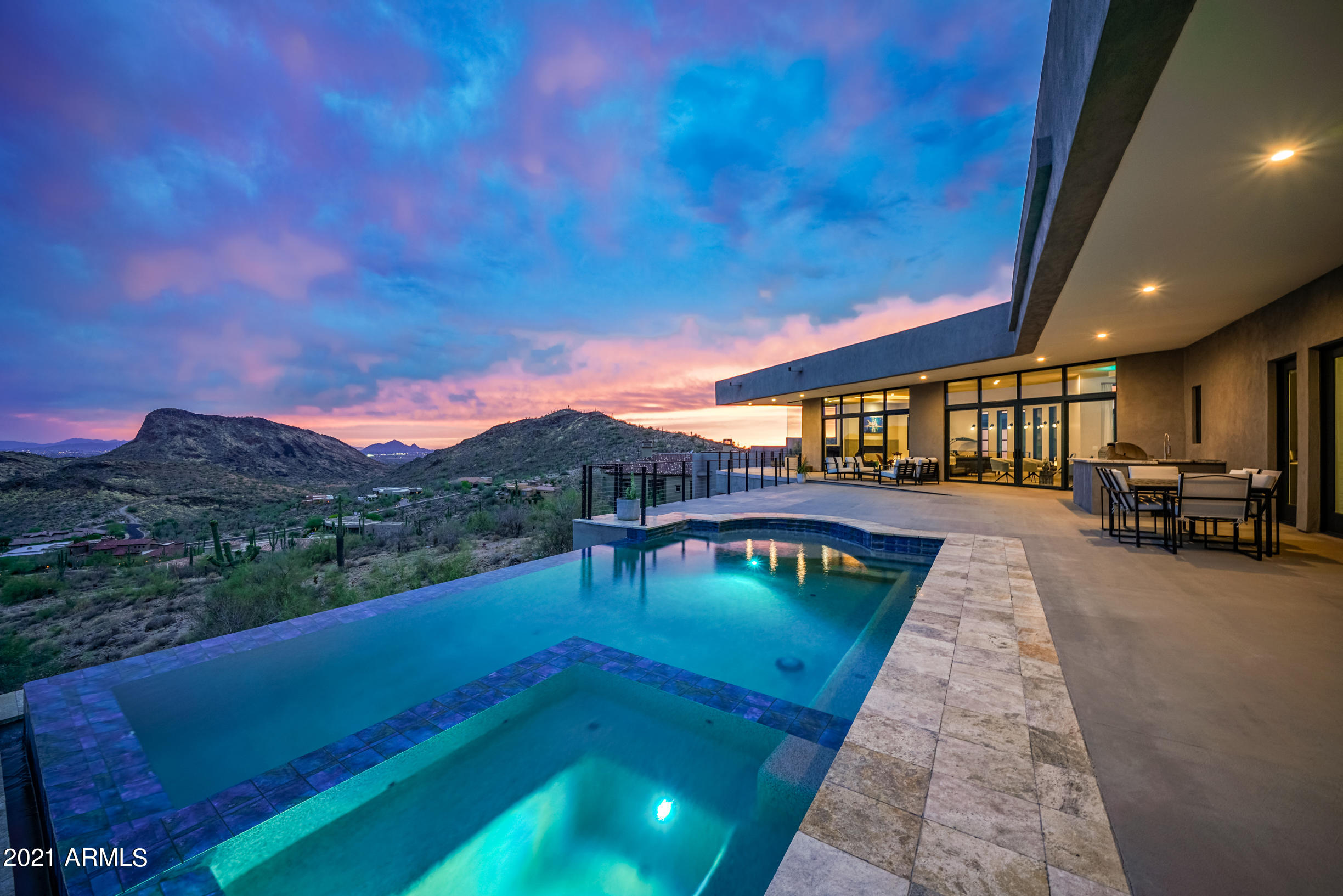 Gorgeous hillside home w/ floor to ceiling windows showcasing 180° panoramic views!  Open concept floorplan to include gorgeous European chefs kitchen with Miele induction cooktop, Bosch ovens & quartz waterfall island. Oversized primary bedroom with 2 way fireplace and a walk in shower you have to see. 2 large offices with custom metal & glass walls, 75 bottle wine room.  Light & bright lower level offers 10 ft ceilings, 2 en-suite br, wet bar, powder room, additional living area, oversized bonus room that can be customized (gym, theater room) and a private patio. Enjoy the negative edge pool with baja shelf & spa as well as the built in BBQ on 1 of 3 patios.  4 HVAC, 2 tankless water heaters, whole house water conditioner, LED lighting, Smart home features.