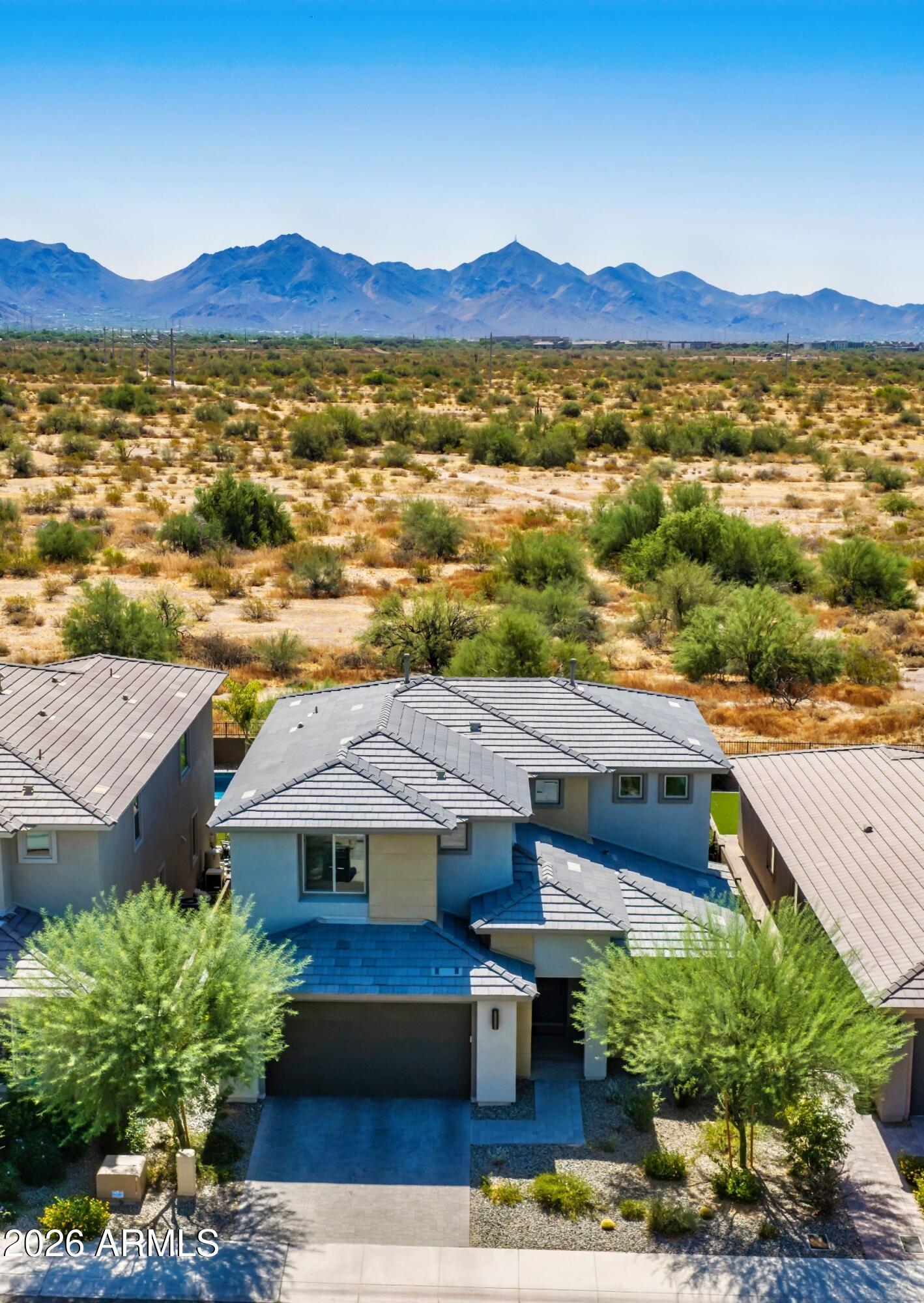 Wake up to stunning mountain views in this nearly new home in the gated community of Talinn in Desert Ridge. Set on a premium cul-de-sac lot, this thoughtfully designed home offers the perfect blend of modern design, flexible living & one of North Phoenix's most desirable lifestyles. The popular Prato plan features nearly 3000sf with 5 bedrooms, 4 bathrooms, a versatile loft & an oversized 2.5-car garage with an EV charger & ample storage.

Enjoy the convenience of a private first-floor primary suite featuring dual sinks, a beautifully tiled shower and a spacious walk-in closet. A second downstairs bedroom and full bath offer exceptional flexibility for guests, multigenerational living, or a home office.

The well-appointed kitchen features quartz countertops, a gas cooktop, abundant cabinets, and an oversized island overlooking the dramatic two-story great room with built-in surround sound.

Step through the large sliding glass doors to your private backyard, where stunning mountain views create the perfect setting for morning coffee, evening sunsets, and outdoor relaxation. Located on a premium cul-de-sac lot with no through traffic, this home offers privacy and tranquility.

Talinn offers one of Desert Ridge's most desirable gated community lifestyles with a clubhouse, swimming pool, and convenient access to Loop 101 and SR 51. Everyday conveniences are just minutes away with Sprouts Farmers Market and Trader Joe's coming soon nearby, while shopping, dining, and entertainment options abound at Desert Ridge Marketplace, CityNorth, Kierland Commons, and Scottsdale Quarter.