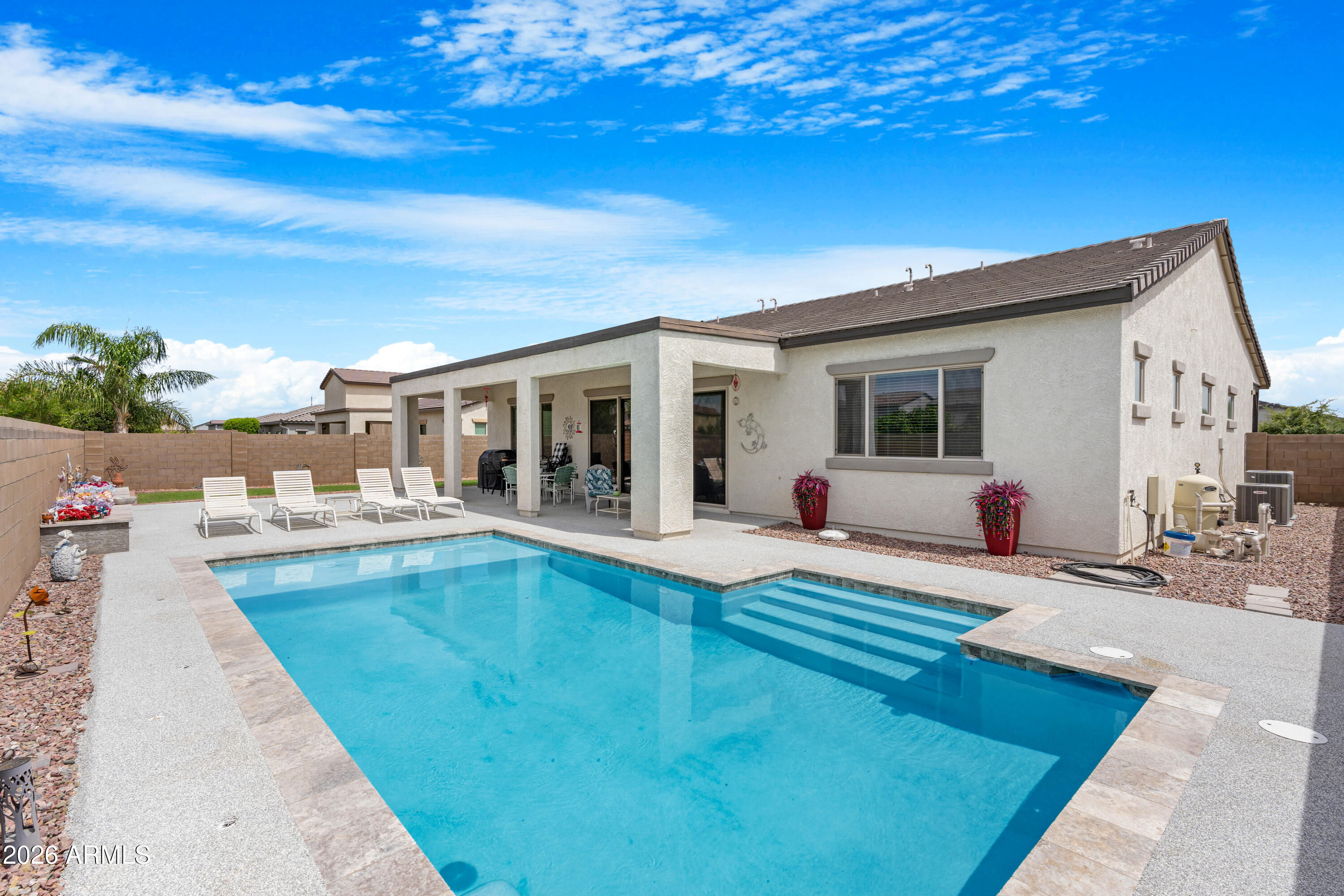 Summer is calling and this home is ready to answer. Nestled against the breathtaking backdrop of the White Tank Mountains, this Elliot Home delivers the lifestyle upgrade you've been waiting for. Sparkling private pool, a dedicated RV garage, and an oversized RV gate, all wrapped in one of the West Valley's most sought after, master planned communities. Inside, you'll find an open, thoughtfully designed layout with tile in common areas, eat in kitchen, all set against stunning mountain views just beyond your windows. Split floorplan offering 4 bedrooms 3 baths, plenty of space for everyday living.