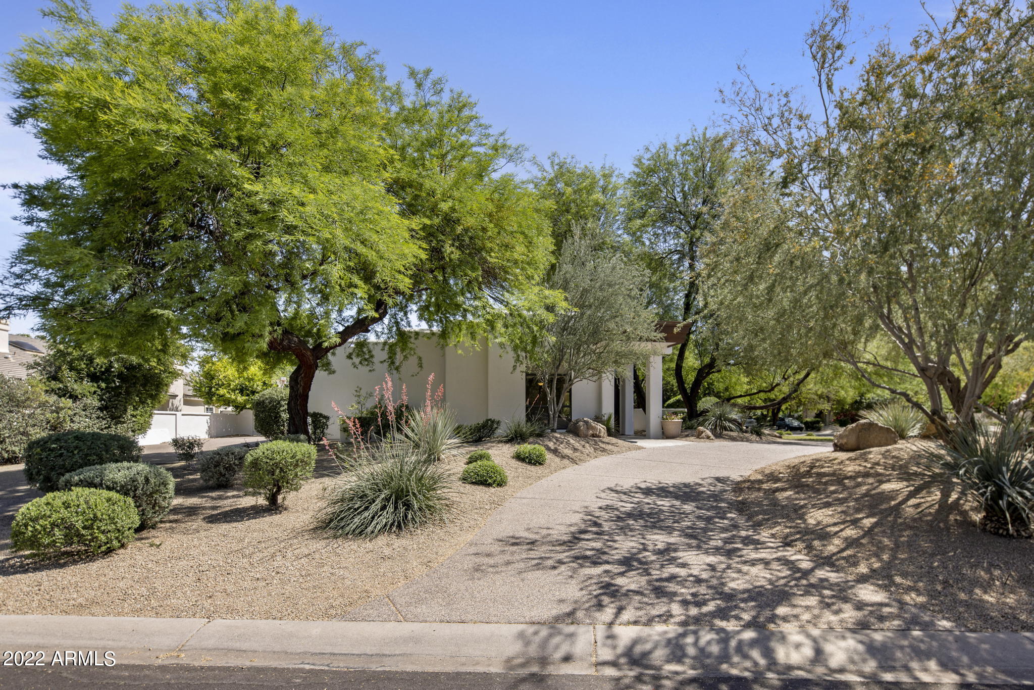 Welcome to your new home in the exclusive gated community of Cantatierra in the heart of Paradise Valley. A beautiful open floor-plan features high ceilings, an oversized great room, living room, wet bar, formal dining, formal office/library and a chef's kitchen. This sophisticated, modern desert home offers a  private resort style backyard, perfect for providing relaxing indoor / outdoor living. The private backyard embodies superb resort living with the following amenities-  putting green, tranquil pool, spa, gas fire pit and an outdoor kitchen. This home has been tastefully remodeled with close attention to detail. The exquisite caliber of design, coupled with premier quality and finishes, have created an exceptionally elegant home. This spectacular property is a must see.
