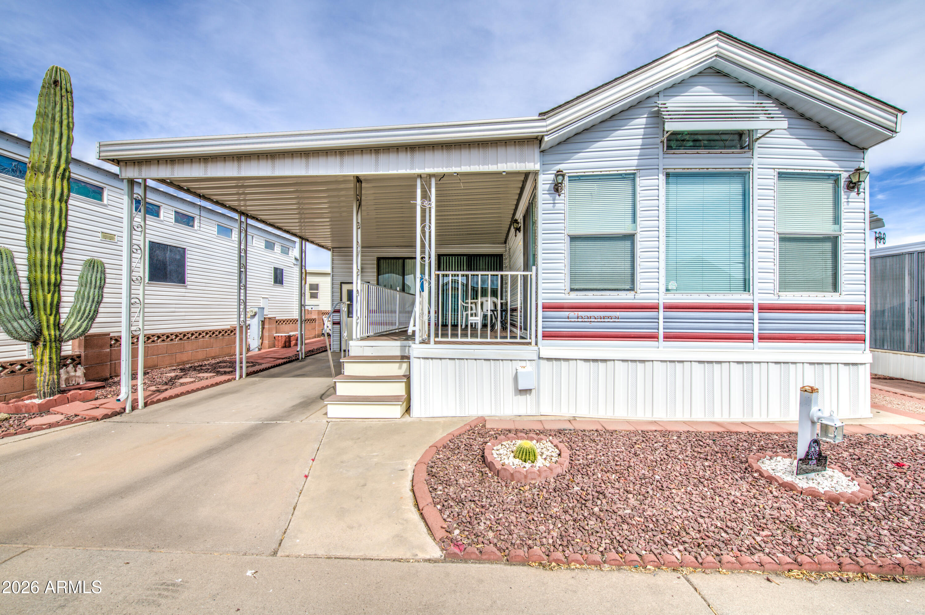 Beautifully maintained West facing home in Carriage Manor Resort, a premier 55+ Community where you OWN THE LAND! Outside you have a very nice custom Trex deck, roof shingled in 2018 and under the house you have all PEX plumbing. Inside you'll find gorgeous laminated floors. Sleeper sofa in front living room and 2 sleeper sofas in the large Arizona room. Carriage Manor has 24/7 on site security, a heated SALTWATER pool/spa, fitness facility, Tennis, Pickleball, Bocce, Shuffleboard, Golf Club, Billiards, Lapidary/Silversmith, Ceramics, Glass Art, Sewing, Wood shop, Bingo, Dances parties & many more activities & amenities