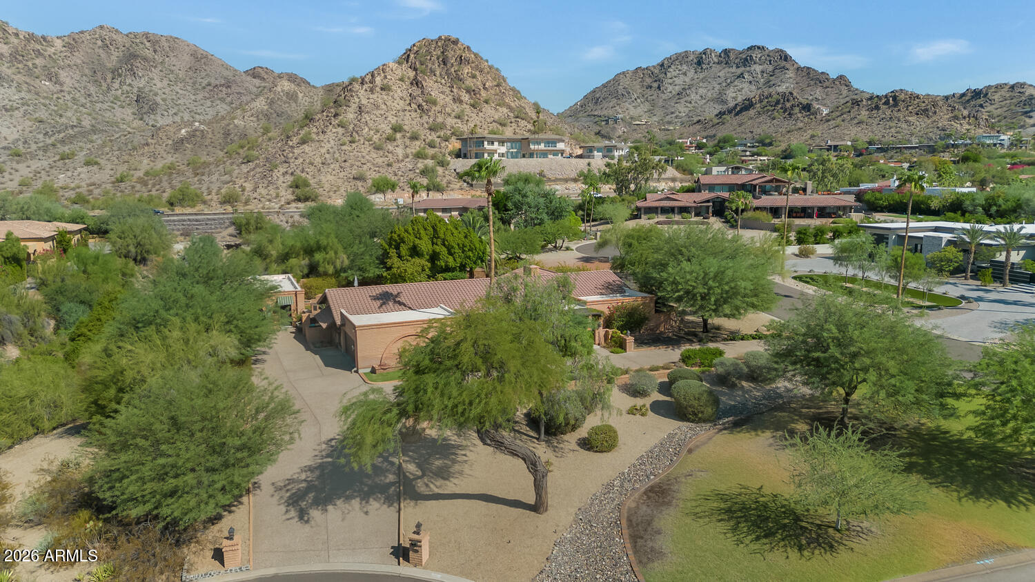 Located in the desirable Biltmore area of Paradise Valley, this inviting home offers spectacular views and a rare opportunity. The residence has been thoughtfully renovated with quality finishes, including hickory flooring, solid cherry cabinetry, Pella windows and doors, and a well-appointed chef's kitchen featuring a Wolf gas range, warming drawer, Sub-Zero refrigerator and freezer, wine storage, slab granite countertops, and convenient pullout shelving. A beautiful guest casita with a full bathroom provides ideal accommodations for visitors, a private office, or flexible additional living space. The outdoor areas include an intimate entry courtyard with a fountain and a low-maintenance backyard with mature landscaping and a fire pit. The home's distinctive slump-block architecture adds warmth and character, while the extraordinary lot and views offer exciting potential to further enhance the existing residence or create something entirely your own. Ideally located near the airport, downtown sporting events, shopping, dining, and many of the Valley's best amenities.