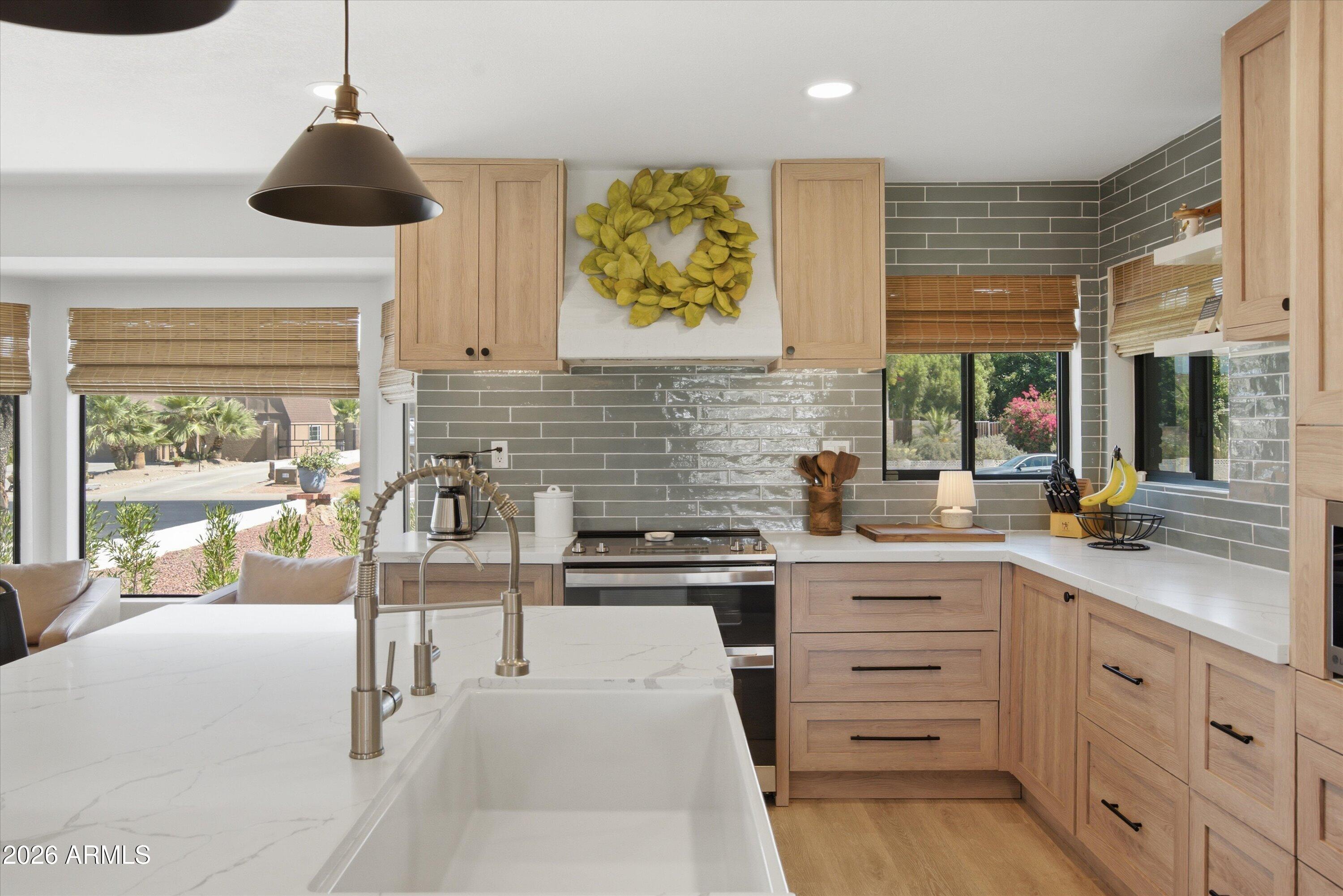 Welcome to this beautifully renovated tri-level home in the highly sought after Sunburst Farms community. Situated on over a half acre of flood irrigated horse property, this exceptional residence offers the perfect blend of modern updates, functionality, and outdoor living. The thoughtfully redesigned open concept kitchen features custom cabinetry, abundant counter space, and newer appliances, creating the ideal space for entertaining and everyday living. The spacious family room showcases attractive wood-look laminate flooring, while the oversized laundry room includes a private bathroom for added convenience. The versatile floor plan offers a lower level family room, a generously sized bedroom, and a full bath perfect for guests or multi-generational living. Upstairs, the primary suite provides a private retreat with a walk out balcony overlooking the backyard. Two additional spacious bedrooms and a full guest bath complete the upper level. Step outside and enjoy everything this incredible property has to offer. The expansive backyard features flood irrigation, room for horses, a garden area, chicken coop, diving pool, covered patio, and a raised deck. Major updates include a new roof and newer HVAC system, providing peace of mind for years to come. Rarely does a property combine acreage, modern upgrades, and the coveted Sunburst Farms lifestyle in one exceptional package.