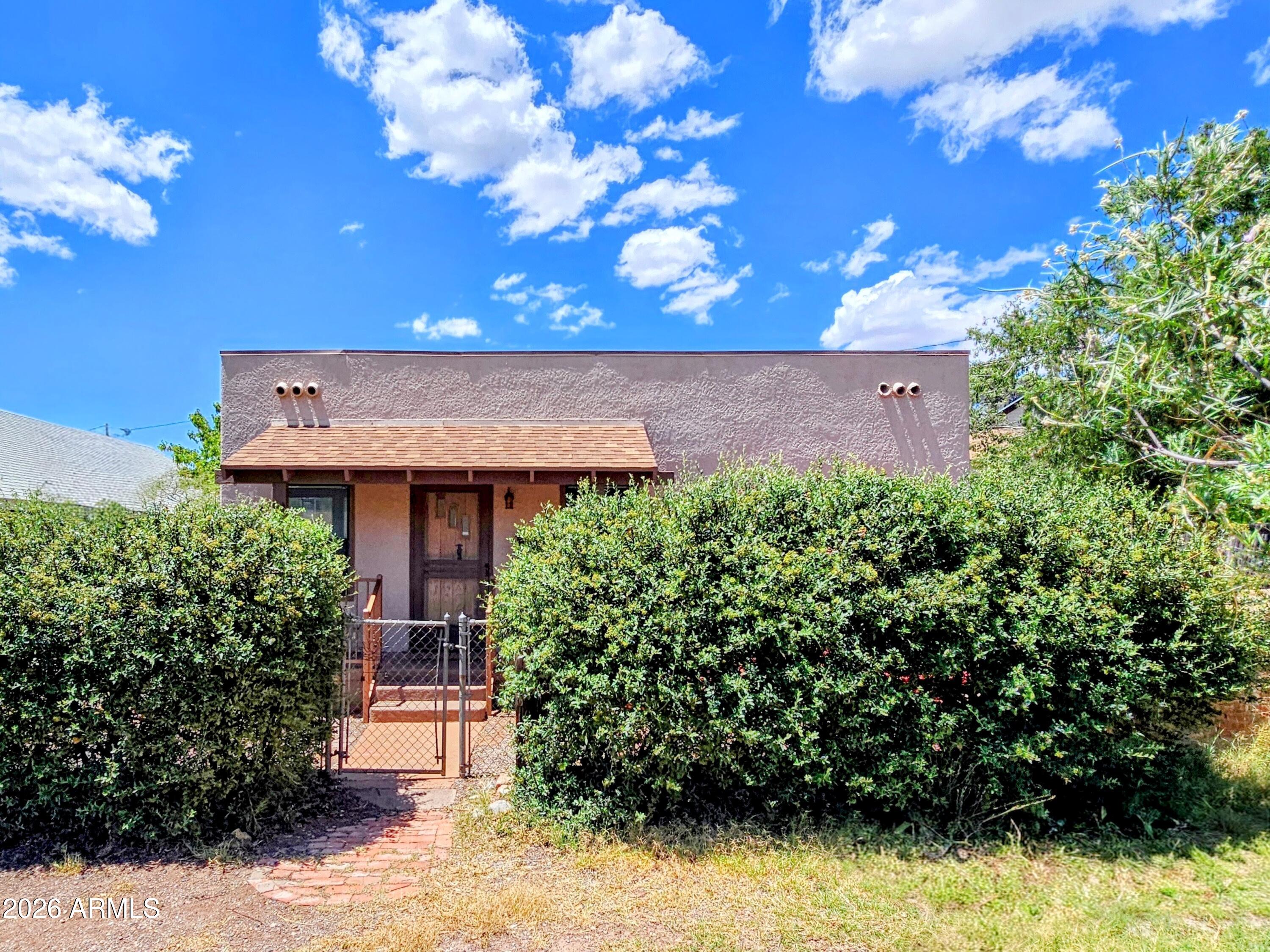 Small Footprint with Big Appeal- 702 sq. ft. 1 Bedroom/1 Bath Territorial Style Home. Solid Block Construction, Built in 1941 with Restored Original Maple Flooring, Built-Ins, and Ornate Gas Fireplace. Walk-In Closet in Bedroom, Judy Perry Murals in Living Room and Kitchen Nook, Storage Shed, Covered Front Porch, and Newer Central Heat and AC.
