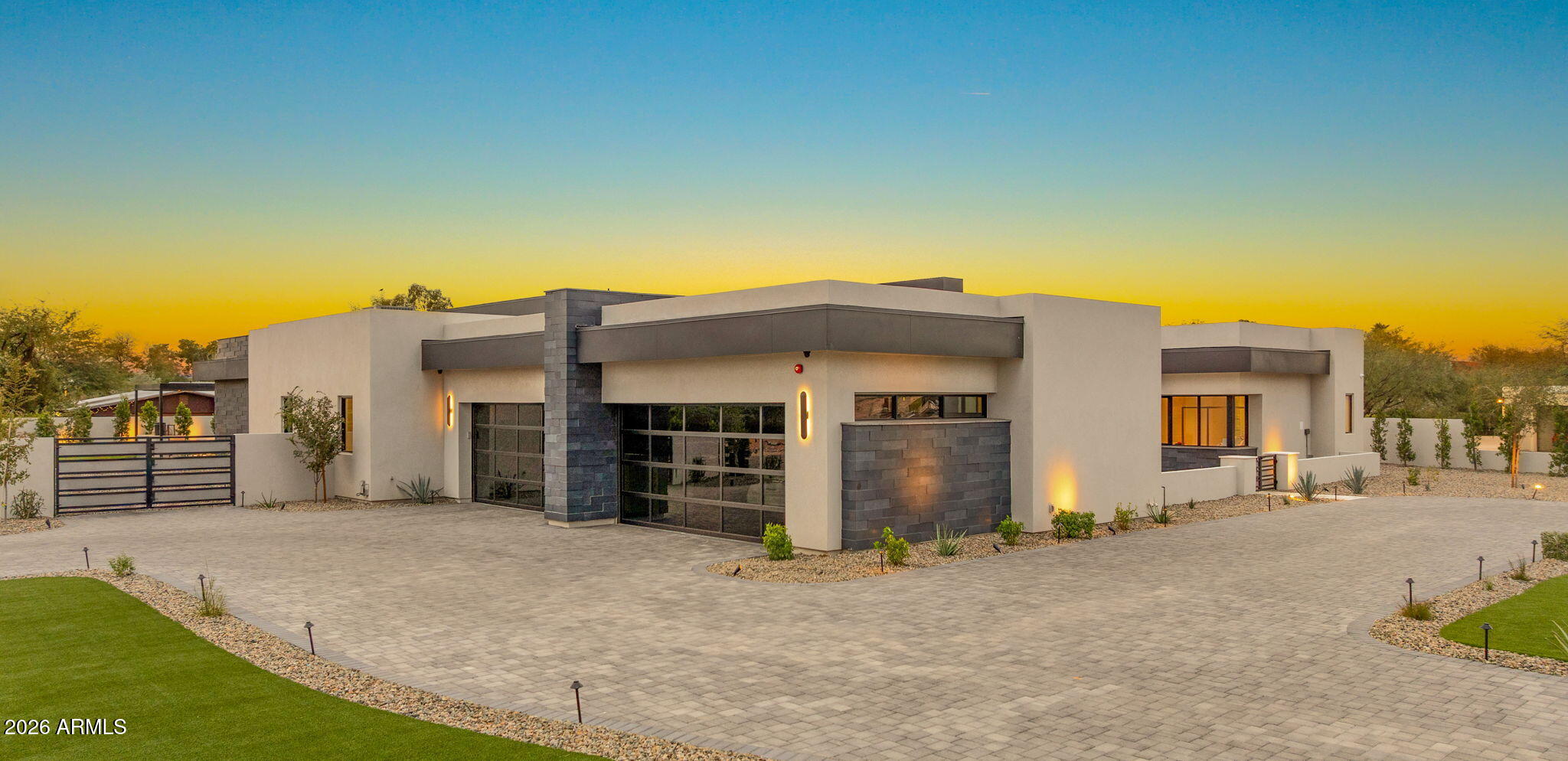 This newly built 2025 contemporary estate in the coveted Cactus Corridor delivers modern luxury and resort-style living. Offering 5,765 total marketable sq ft, including a 5,165 sq ft main residence and 600.7 sq ft guest house, the home features 5 bedrooms, 6 baths, a private movie theater, smart home AV, dual kitchen islands, designer cabinetry, hidden pantry, full bar with wine display, 4-car garage, and a resort backyard with lap pool, spa, BBQ, and batting cage. This newly built 2025 contemporary estate in the highly sought after Cactus Corridor offers the ultimate in modern luxury and resort style living. The main residence spans 5,165 sq ft, complemented by a 600 sq ft guest house, for a total marketable square footage of 5,765 sq ft.
Designed for both entertaining and everyday comfort, the home features 5 bedrooms and 6 bathrooms, a private movie theater, and full smart home AV integration throughout. The chef's kitchen showcases dual islands, designer cabinetry, and a hidden walk-in pantry, flowing seamlessly into a sleek family room with floor to ceiling sliding glass doors, 14 foot ceilings, and a striking modern fireplace perfectly capturing Arizona's indoor/outdoor lifestyle.
Entertain with ease at the full bar, complete with an ice maker, wine fridge, and a temperature controlled wine display. Guests will appreciate the private guest house, while car enthusiasts will love the 4 car garage.
The resort style backyard is truly one of a kind, featuring a lap pool with spa, built-in BBQ, batting cage, and multiple outdoor living spaces ideal for relaxation or hosting unforgettable gatherings.
A rare opportunity to own a brand new, design forward estate in one of Scottsdale's most desirable corridors.