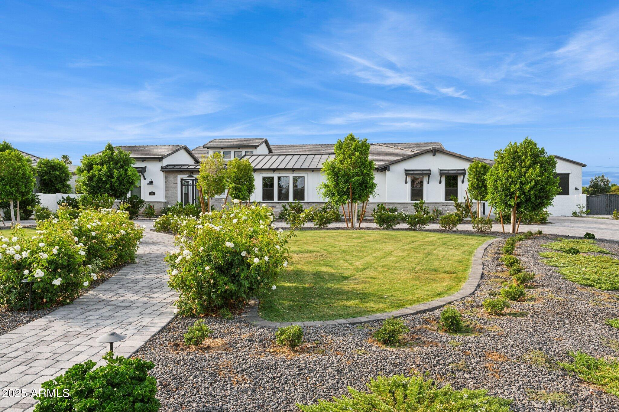 Tucked away at the end of a quiet cul-de-sac in the prestigious gated community of The Estates at Hermosa Ranch, this exceptional single-story estate blends timeless architecture with modern luxury and meticulously curated design. Built in 2021 and situated on a sprawling 40,000+ sq ft lot, this 6,247 sq ft residence delivers sophistication, privacy, and resort-style living at its finest. From the moment you arrive, a custom circular driveway makes a grand first impression offering a dramatic entrance, convenient guest parking, and seamless flow to the home's gated front courtyard. Inside, you'll find soaring ceilings, expansive windows, and a light-filled open floor plan dressed in custom designer finishes, including wide-plank hardwood flooring, artisan lighting, natural stone surfaces, and rich cabinetry throughout.

With seven oversized bedrooms, each with a private en suite bathroom, this home is designed for comfort, flexibility, and refined living. The primary suite offers a spa-inspired experience with a soaking tub, glass-enclosed shower, and dual walk-in closets a private retreat in every sense. 

The gourmet kitchen features top-of-the-line appliances, a massive walk-in pantry, and custom cabinetry that blends beauty with functionality. Additional spaces include a home theater, executive office, and a private two bedroom casita perfect for guests, multigenerational living, or a fitness space.

Step outside into your personal resort-style oasis, where a sparkling pool with waterslide, large covered patio, and lush landscaping provide the ideal backdrop for entertaining or relaxing in style.

The estate also includes a climate-controlled 1,000 sq ft custom RV garage with its own kitchen and full bathroom perfect for RVs, boats, hobby space, or entertaining overflow. A separate four-car garage completes the exceptional vehicle accommodations.

This is a rare opportunity to own a newer, fully upgraded estate with designer touches, exceptional flow, and luxurious amenities all within one of Arizona's most sought-after gated communities.