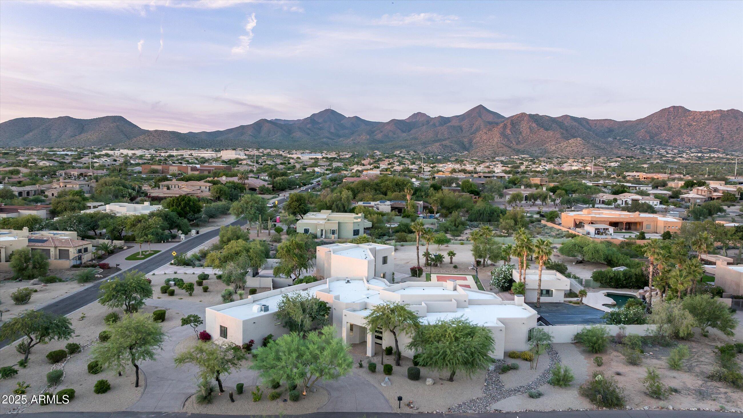 OWNER FINANCING! Hurry! This New Scottsdale Renovated Estate sits on OVER 2 acres and is surrounded by the timeless beauty of the Sonoran Desert. From the moment you arrive, this home reveals itself as a rare blend of modern design and elegance. Inside this full luxury remodel includes: An open space floor plan with vast ceiling heights, 2 sets of expansive glass stacking doors, large format limestone porcelain tile floors & Wood floors throughout, 10' high Iron and Glass Pivot Entry door, Inside out Linear modern gas Fireplace, Programmable LED lighting and Home System, EVERY BEDROOM with its OWN ENSUITE BATH, Mother in Law Suite-Casita w/Full Kitchen and separate entrance. Sophisticated Kitchen and bar area w/2 Tone Custom Cabinetry and Sub Zero-Wolf appliances. Extra Large Chefs Walk in Pantry w/Wet Sink, and ample closed and open storage, Temperature controlled Wine room w/192+ Wine Bottle Storage, Premium Black and White Dalmata Polished Marble Slab Countertops w/Waterfall sides on an extra long 13+' floating kitchen island. 

Primary Bath has 55" round free standing tub w/a contemporary 48" LED hanging gold light fixture above, Multi Function Rain Shower system built into ceiling, floor to ceiling and all over Floor Onyx Look Large Format Porcelain Tile, LED Vanity Mirrors, Huge His and Hers Walk in Closets and a Kohler Bidet Toilet. 

Laundry Room has 2 Stackable Laundry Stations each containing a Full Size Washer and Dryer, a wet sink with lots of upper and lower cabinetry as well as a wall w/full size storage. 

Entertaining and Multipurpose areas are a plus. There is a Great Room off the Foyer for your main entertaining, a large upstairs loft area family room with an amazing view of the backyard oasis that also has a hidden storage area. 

Downstairs off the garage there is an area with its own courtyard that can either be a gym, a kids playroom, a Home Theater area or anything else you want it to be - it has a key drop cabinet and a beverage bar area . 

Outdoor area - A property of this scale offers opportunities rarely found in Scottsdale. You can do anything that is in your imagination here. Right now there is a Gazebo w/a BBQ area, a firepit, Resort Type Pool, a pool house equipped with a dishwasher, wet sink, ice maker and beverage refrigerator as well as stairs that lead up to a view deck to relax and see the stars and lights at night! 

This is more than a remodel; it is a complete reinvention of Scottsdale luxury living, where modern comfort, architectural refinement, and breathtaking mountain views come together on an irreplaceable 2 plus acre canvas.
Outdoor living is equally spectacular. Expansive patios wrap around the home, leading to an air conditioned retreat off of the play pool, both overlooking the endless desert. With generous space for dining, entertaining, or simply unwinding, the exterior becomes an extension of the home's luxurious ambiance.

A property of this scale offers opportunities rarely found in Scottsdale: room for a guest casita, car collection, sport courts, horses, or simply the peace that comes with owning a private desert retreat.

This is more than a remodel it is a complete reinvention of Scottsdale luxury living, where modern comfort, architectural refinement, and breathtaking mountain views come together on an irreplaceable 2 plus acre canvas.