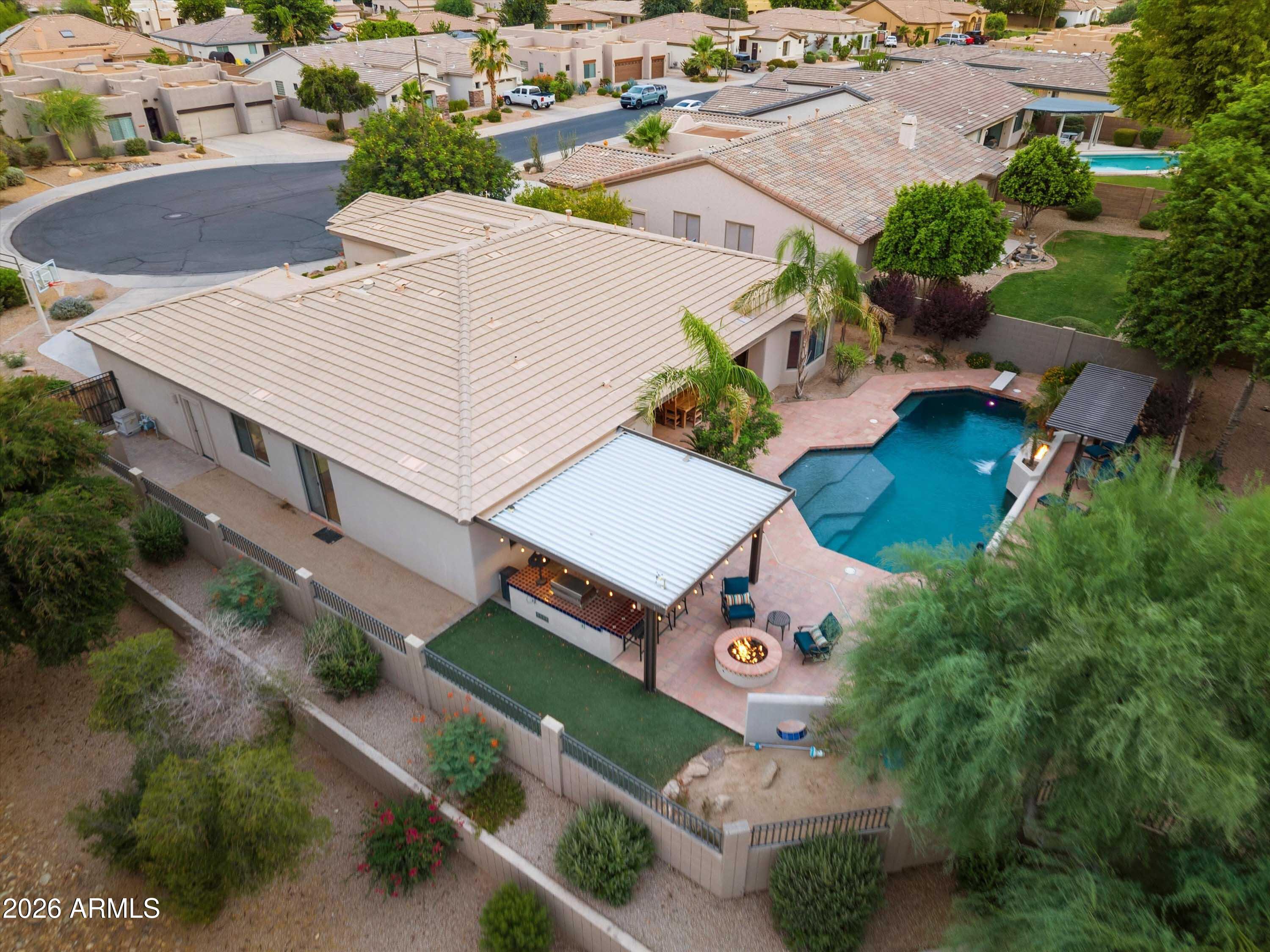 Welcome to this exceptional home offering the perfect blend of comfort, functionality, and resort-style living. Featuring 4 spacious bedrooms, a dedicated office, and a true den, this thoughtfully designed split floor plan provides flexibility for work, relaxation, and entertaining. The remodeled kitchen is the heart of the home, showcasing updated cabinetry, quality finishes, a large center island, and seamless flow into the open-concept living spaces. The 3-car garage provides ample storage and parking. Step outside to your private backyard oasis complete with a sparkling pool, spa, water feature, expansive covered patio, and outdoor kitchen, creating the ultimate setting for Arizona living, entertaining, and year-round enjoyment.