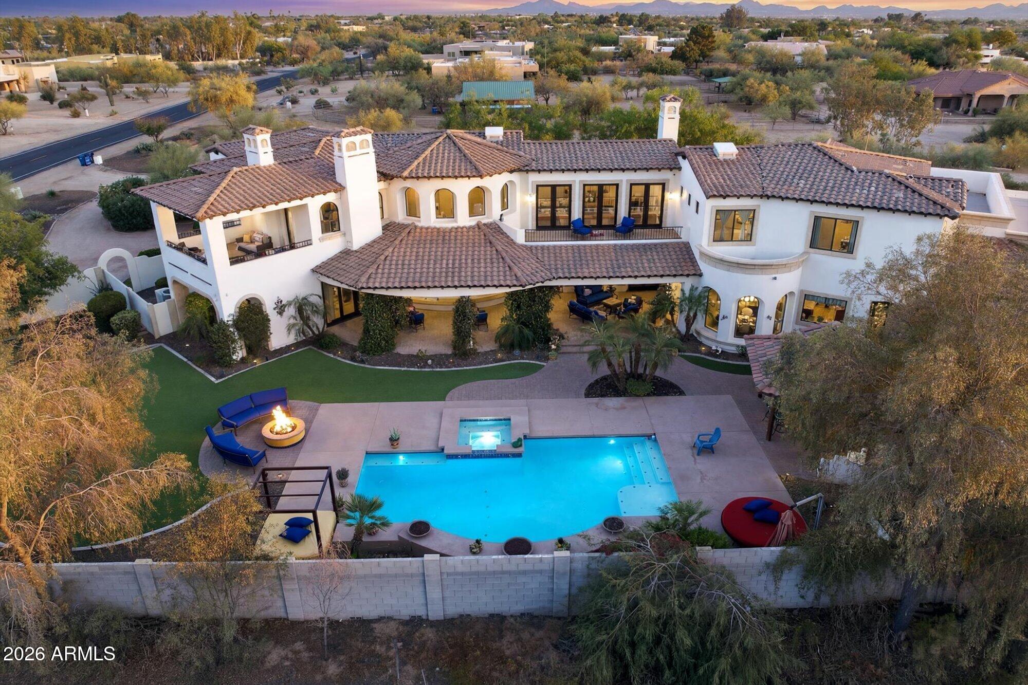 'Hacienda Del Sol' Come enjoy the benefits of luxury, location and lifestyle with this rare desert oasis. Situated on approximately 2.5 acres of breathtaking acreage with open land to develop into whatever you desire. 270 degree panoramic views from over 1700 SF of patios & balconies with 80 miles of scenic views of AZ mountain ranges and amazing sunsets. The resort style backyard is designed for entertaining, outdoor firepits, water features, and an outdoor kitchen for entertaining. No HOA and both lots will be sold together. 24 hrs. Notice to tour. Listing Agent will be present.
