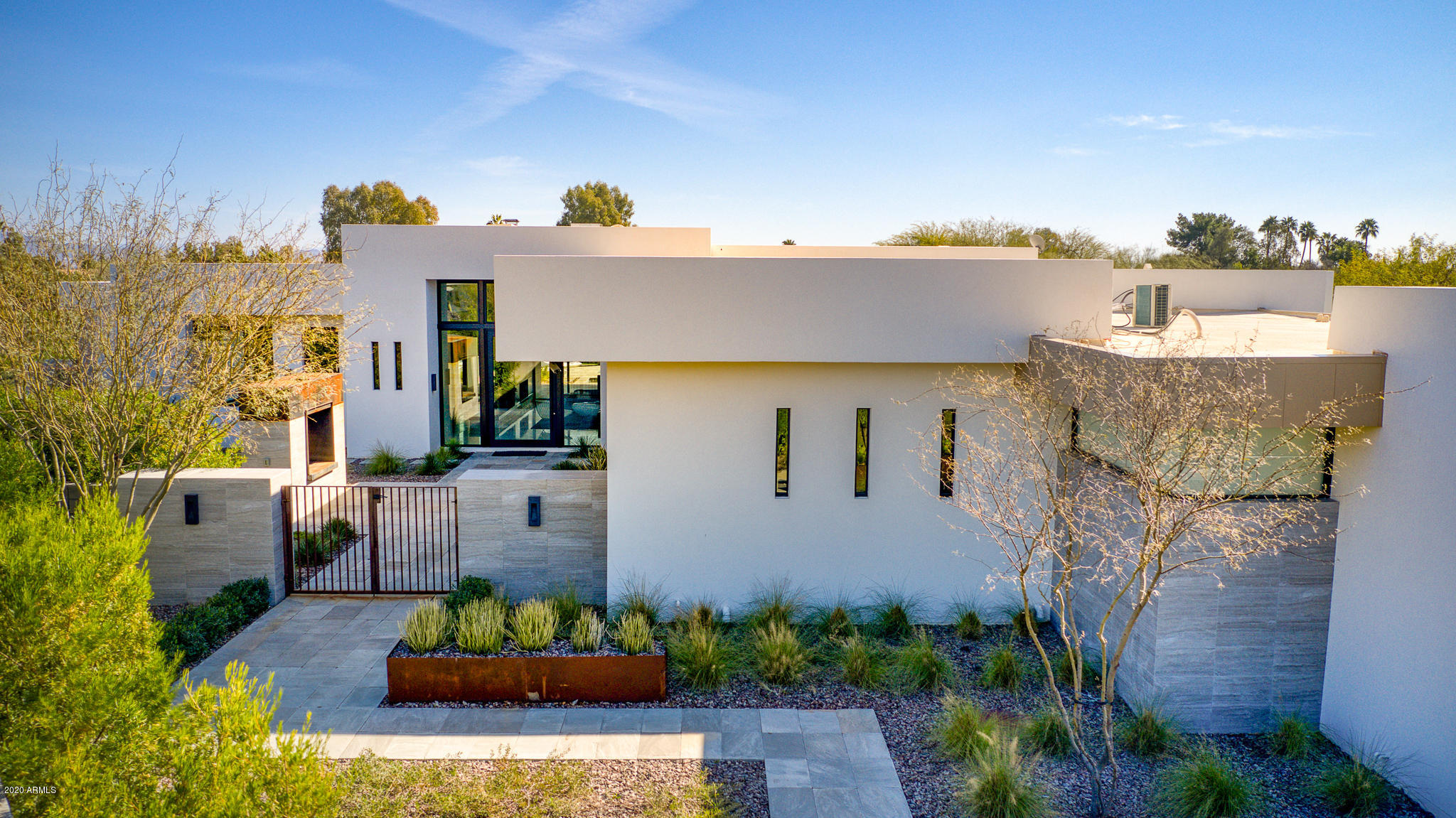 Love Where You Live in this 5590 sq/ft modern home on a secluded lot in KACHINA ESTATES! Home boasts modern opulence with state of the art finishes. The home offers a large master suite with HUGE closet, large tub and walk in shower.  3 additional bedrooms, each with an en-suite bath are split from the Master. The chef's kitchen and great room open to a covered outdoor living area through expansive, retractable glass doors that lead to your pool and private spa. A dining room with wine storage and butler's pantry allows for endless entertaining opportunities. The theater room plus an office/playroom and home automation allow for total home flexibility.  All of this on a private lot with 4 car garage and gated driveway!  Show today and welcome home!