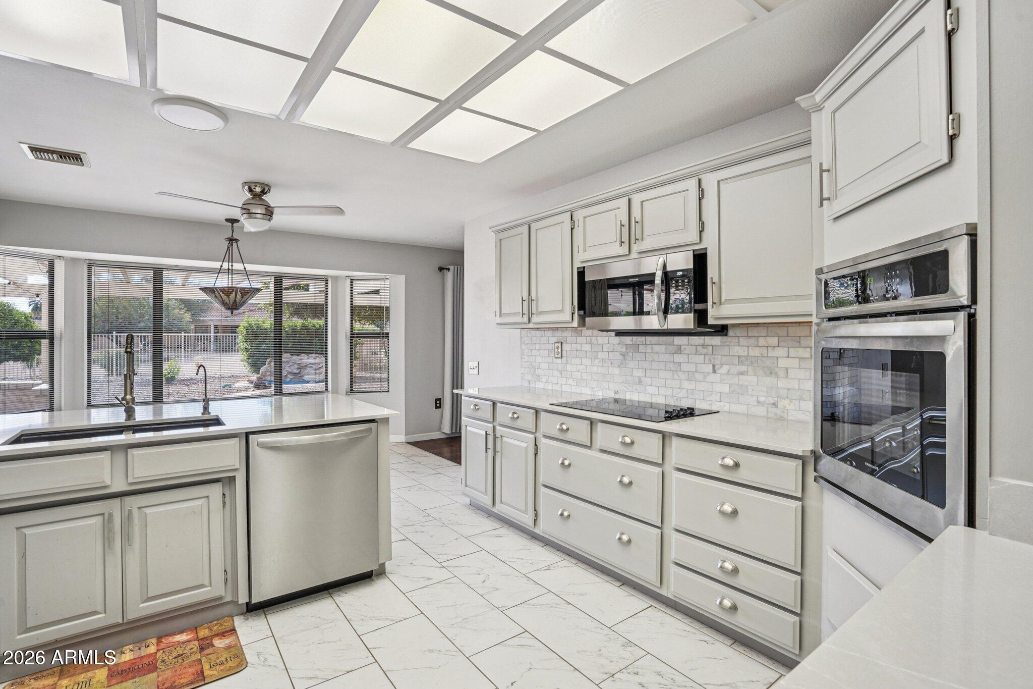 Discover your perfect desert retreat & get ready to ditch your electric bills!  This tastefully updated 3/2 San Simeon model boasts 2528sf on an enormous & rare .3 acre fully fenced lot, all w tons of storage. Plenty of room to relax & entertain. 
Enjoy an open great room w vaulted ceilings, a modern kitchen w Quartz counters & SS appliances & Owned Solar for lower energy costs or even a rebate check.  
The fenced back yard w a huge covered patio is ideal for outdoor entertainment or private enjoyment. Newer A/C units & roof peace of mind. Located in Sun City West w all the amenities like 7 golf courses, performance theater, state of the art fitness centers, shopping & dining for every taste. Sun City West offers a vibrant active lifestyle w quality healthcare.