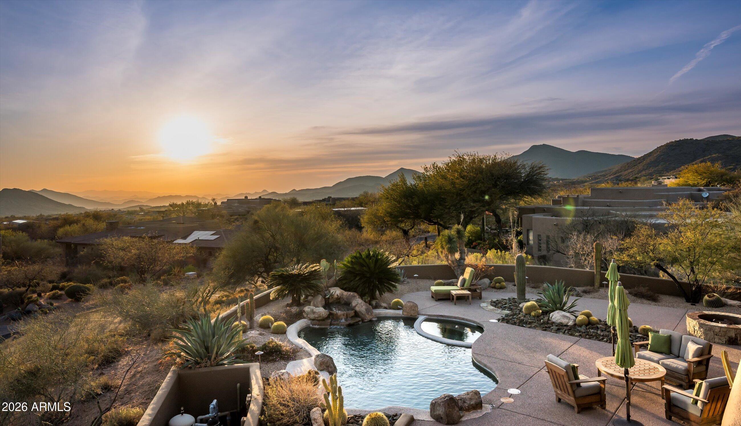 Desert Mountain Golf Membership Available - Set against the untouched beauty of North Scottsdale, this home in the coveted Apache Peak village of Desert Mountain embodies understated luxury and sophistication.  From the moment you arrive, the elevated south-west facing setting commands attention - with sweeping views of the valley and the city lights, dramatic mountain backdrops, and a sense of seclusion that feels worlds away yet effortlessly connected.
Designed to celebrate both scale and serenity, the residence is filled with natural light and expansive sightlines that frame the Sonoran Desert like living artwork.  Interiors are thoughtfully curated, blending refined finishes with architectural warmth to create spaces that feel both grand and inviting. Each room flows seamlessly, ideal for elegant entertaining or intimate everyday living, with the expansive GROUND- FLOOR master bedroom and library/office (or fourth ensuite bedroom) separated from a second master bedroom, ensuite guest room, sitting area and viewing terrace on the second floor.
The main living areas open beautifully to the outdoors, creating an effortless indoor-outdoor lifestyle that defines luxury Arizona living.  Whether hosting sunset gatherings or enjoying quiet evenings beneath the stars, the home offers an atmosphere of calm sophistication at every turn.
Outside, the property becomes a true retreata private sanctuary both peaceful and immersed in nature.  The 270-degree views of the valley, open skies, and carefully integrated desert landscaping provide an unparalleled sense of space and exclusivity.  Every moment here feels intentional, from morning light across the mountains to dramatic sunsets and the glow of twilight settling over the valley.
Discover this unparalleled lifestyle at this exquisite luxury residence nestled within one of North Scottsdale's most coveted enclaves, this exceptional property offers privacy while centrally located on the Mountain allowing for quick and easy access to all Desert Mountain amenities.