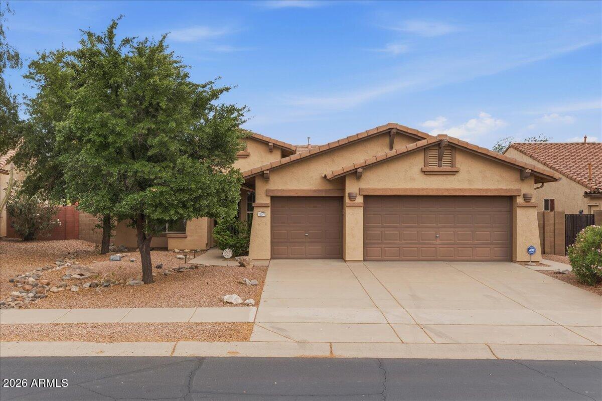 Spectacular home in the highly sought-after Peralta Trails community in Gold Canyon! This single-level home offers 3 bedrooms, 2 bathrooms, and 1,859 sq ft with a spacious and functional great room floor plan. Featuring 10-foot ceilings, abundant natural light, and an open layout, the living room and kitchen overlook the backyard, creating a seamless indoor-outdoor living experience. The kitchen includes solid surface countertops, tile backsplash, and stainless steel appliances.The home also offers a versatile den/flex space, generously sized bedrooms, and ample storage throughout. Additional highlights include a 3-car garage, large laundry room, and ceiling fans in every room.Step outside to enjoy a covered patio, private backyard, and beautifully updated desert landscape.