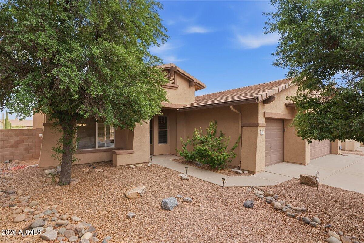 Spectacular home in the highly sought-after Peralta Trails community in Gold Canyon! This single-level home offers 3 bedrooms, 2 bathrooms, and 1,859 sq ft with a spacious and functional great room floor plan. Featuring 10-foot ceilings, abundant natural light, and an open layout, the living room and kitchen overlook the backyard, creating a seamless indoor-outdoor living experience. The kitchen includes solid surface countertops, tile backsplash, and stainless steel appliances.The home also offers a versatile den/flex space, generously sized bedrooms, and ample storage throughout. Additional highlights include a 3-car garage, large laundry room, and ceiling fans in every room.Step outside to enjoy a covered patio, private backyard, and beautifully updated desert landscape.