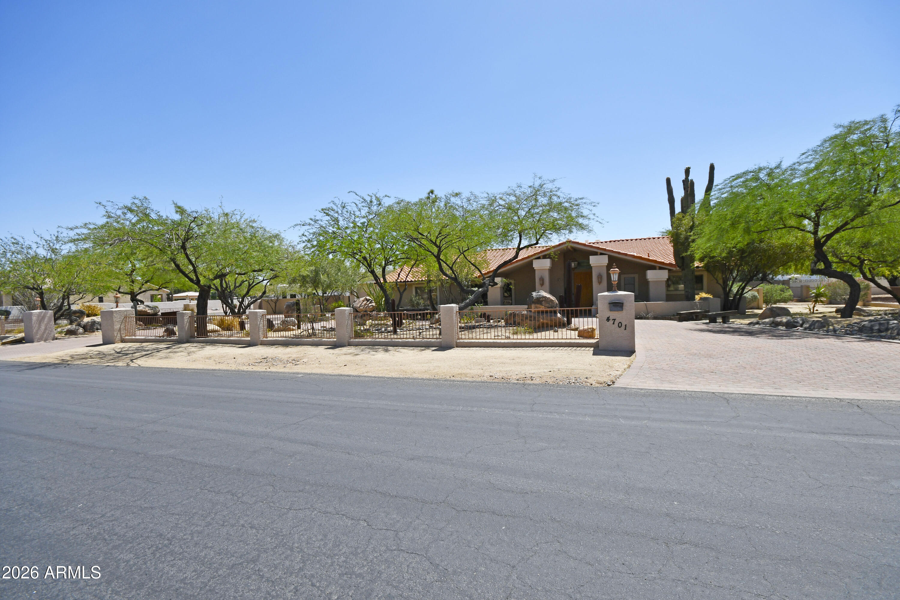 This beautiful custom home is a must see and features 12' ceilings, exposed beams, large open chef's kitchen, upgraded appliances,  large pantry, oversized family room with wet bar,  formal dining room, 4 large bedrooms, 3 full baths, extra large master bedroom with double vanities, snail shower, oversized closet, and Saltillo tile throughout.  House is located on a fully blocked fence lot, electric R.V. gate with over an acre N/S lot with sparkling dive pool, 3 car garage with 16' doors to accommodate large vehicles,  wrap around patio's, extensive bbq area with built in seating areas, a studio with water and ac,  separate large work shop with power, two car garage door, swamp cooler, numerous storage sheds, fenced in and meshed garden area. Great location to schools, shopping, & highways