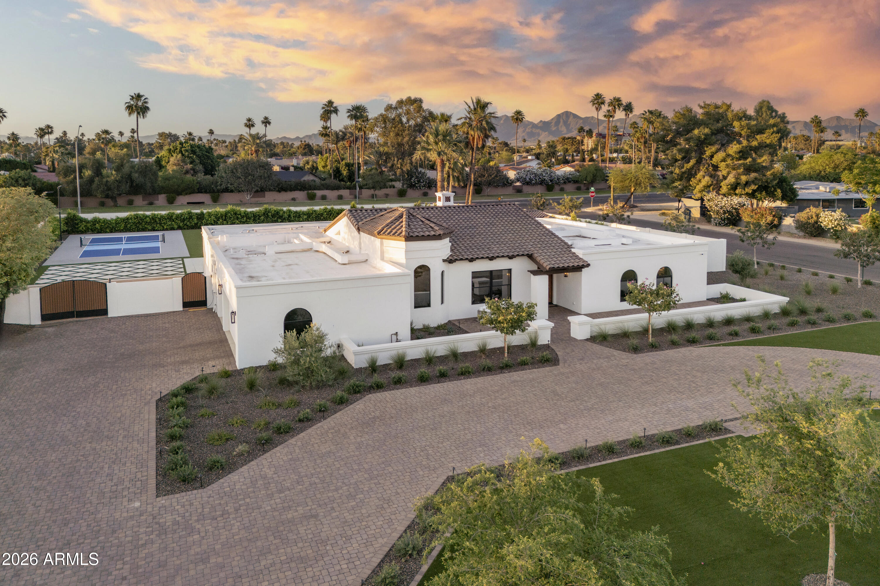 In Indian Bend Ranchos, where land has become one of the last true luxuries, this 38,089 sq ft corner property with only one direct neighbor, stands apart for a simple reason, there is nothing compromised about it. Set within a private collection of custom homes, with no HOA, it offers a kind of freedom that's increasingly rare. 
Every SQFT has been thoughtfully utilized and REBUILT IN 2025 , while still offering the opportunity to expand and create additional value. A warm Santa Barbara sensibility runs throughout, expansive in scale, balanced in proportion, and restrained in tone. Vaulted wood-beamed ceilings give the interiors height and presence, while a quiet palette allows the materials and light to speak for themselves. This estate has been reworked in its entirety, with a level of finish that remains consistent from one space to the next. At the center, the kitchen is substantial, with custom cabinetry, stonework, and a walk-in pantry, opening seamlessly to the main living areas and beyond. The layout is resolved with clarity, including a split primary suite that offers privacy without disconnect.
Outdoors, the property reveals its full advantage. A custom NanaWall system allows the main living spaces to extend directly to the terrace. A covered outdoor living area with a full kitchen anchors the rear of the home, while a private pool and separate pool house introduce flexibility, equally suited for guests or a more personal retreat. Beyond, a fully lighted pickleball court and an uninterrupted stretch of manicured turf create something rarely found at this level: space that is both generous and entirely usable.
A composed arrival, structured landscaping, and a three-car garage with the ability to expand complete the experience. It simply gets it right.