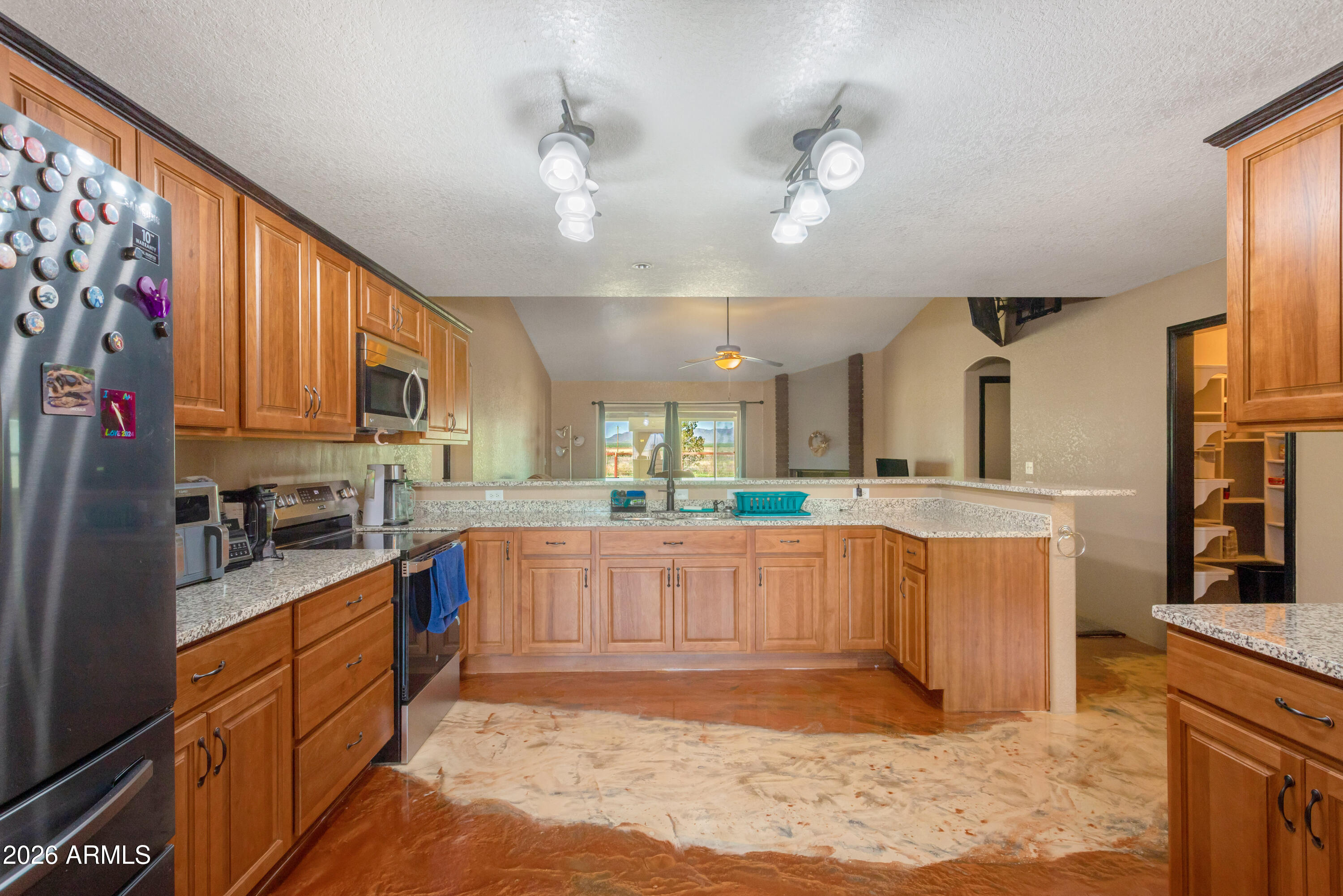 Enjoy wide open space and breathtaking 360° views with this custom 3-bedroom, 2-bath home situated offering 2,728 sq ft, on 25 acres of peaceful countryside. Designed with a desirable split floor plan, the home offers privacy and functionality with spacious living areas throughout.   Inside, you'll find both a living room and a separate family room, providing plenty of space for relaxing or entertaining. The heated and cooled sunroom offers a bright and comfortable space to enjoy the surrounding landscape year-round.   A standout feature of this property is the 2,300 sq ft fully equipped dog kennel facility, perfect for breeders, trainers, or animal enthusiasts. The kennel includes five runs, grooming space, temperature-controlled areas, security cameras, and a convenient half bathroom, creating a professional and efficient setup for animal care.  The entire 25 acres is equipped with an invisible dog fence, allowing pets to roam freely while remaining safely contained. Additional features include a private well and a security system that will convey with the home for added peace of mind.  With expansive acreage, incredible panoramic views, and specialized facilities already in place, this property offers a rare opportunity for country living with a turnkey animal care operation.