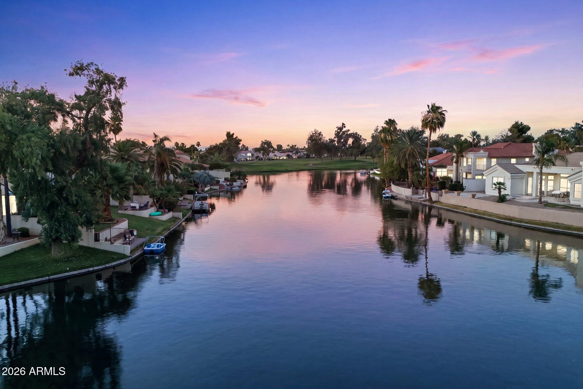 ARE YOU READY TO FALL IN LOVE??? Rare waterfront location features shimmering lake water views.  Enjoy your slice of paradise in this gorgeous updated home featuring a recent roof, updated laminate & carpet flooring, custom interior paint, remodeled master bathroom, updated kitchen with stainless appliances and granite counters, modern lighting throughout.  A sleek contemporary vibe in tones of grey and white will match any decor. Darling laundry room with custom cabinets/built-ins for an efficient space. Cool sparkling blue play pool, extra large patio area for entertaining in style with a lush green grassy yard spanning to the shoreline of the lake. This home shows like a postcard and is a rare find~! Did I mention the 3 car garage~!?HURRY!!