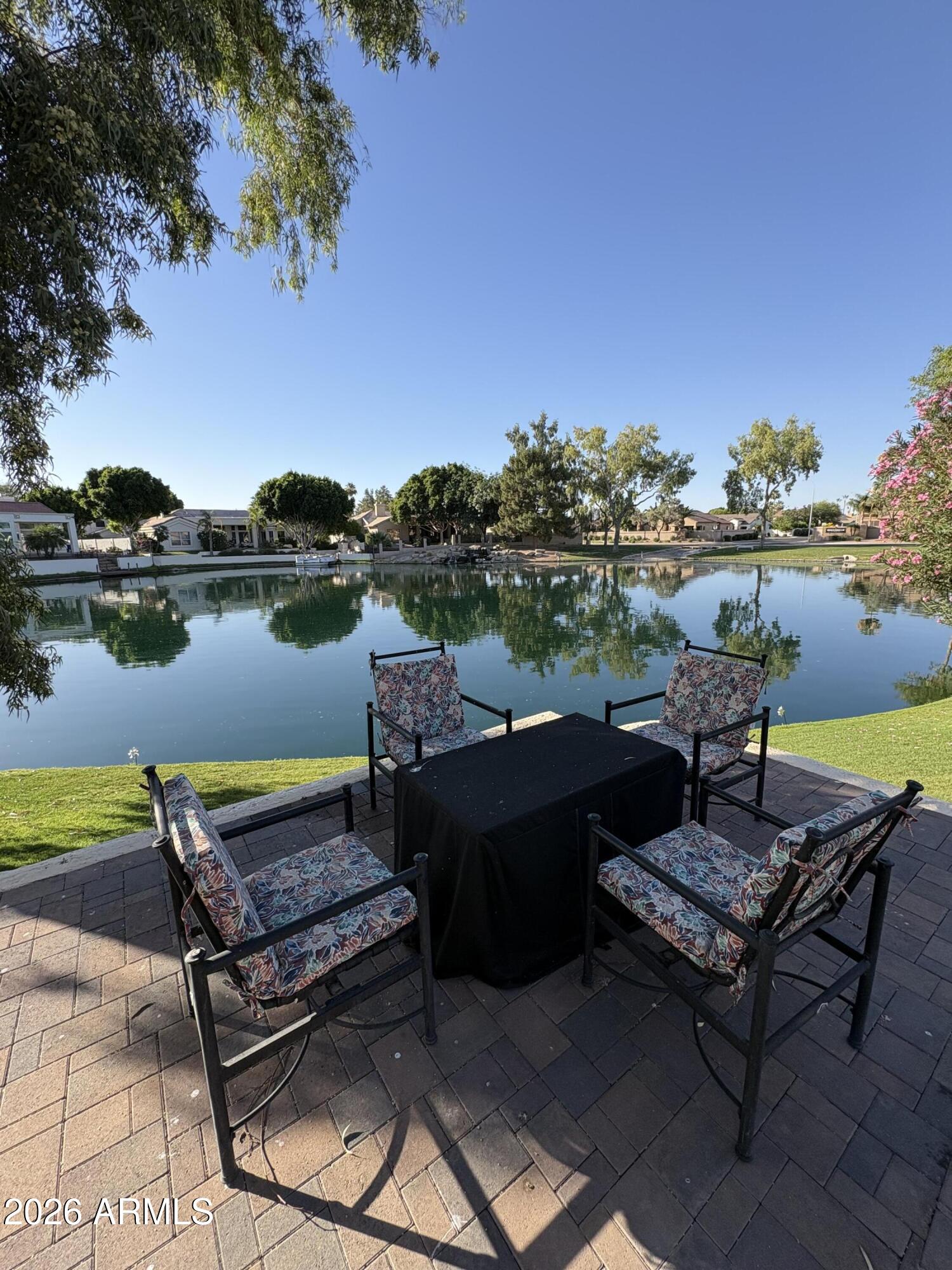 ARE YOU READY TO FALL IN LOVE? ???
Rare waterfront location features shimmering water and panoramic mountain views.  Enjoy your slice of paradise in this gorgeous updated home with a recent roof, updated laminate flooring, interior paint, remodeled master bathroom, updated kitchen, modern lighting throughout.  A sleek contemporary vibe in tones of grey and white will match any decor.  Cool sparkling blue play pool, extra large patio area for entertaining in style with a lush green grassy yard spanning to the shoreline of the lake. This home shows like a postcard and is a rare find~! HURRY!!