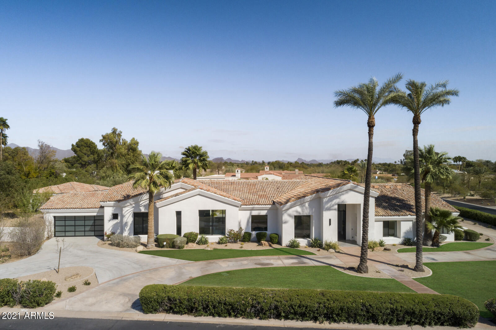 This ultra-modern Mediterranean home is tucked away in one of Paradise Valley's most desirable neighborhoods. Extra-large custom windows throughout offering stunning views of Mummy Mountain. All 5,100 square feet were gut rehabbed in 2015 with all new electric, plumbing, HVAC, and smart home. Concrete floors throughout. European kitchen with top-of-the-line appliances. Custom Crestron home automation system with indoor and outdoor speakers, automated shades, lighting, HVAC, and audio/video. Saltwater, infinity edge pool with spa and outdoor shower. Fruit trees and irrigated chef's garden. Secluded and detached 780 square feet guest house with all the amenities of a home and its own driveway. This gem won't last long.