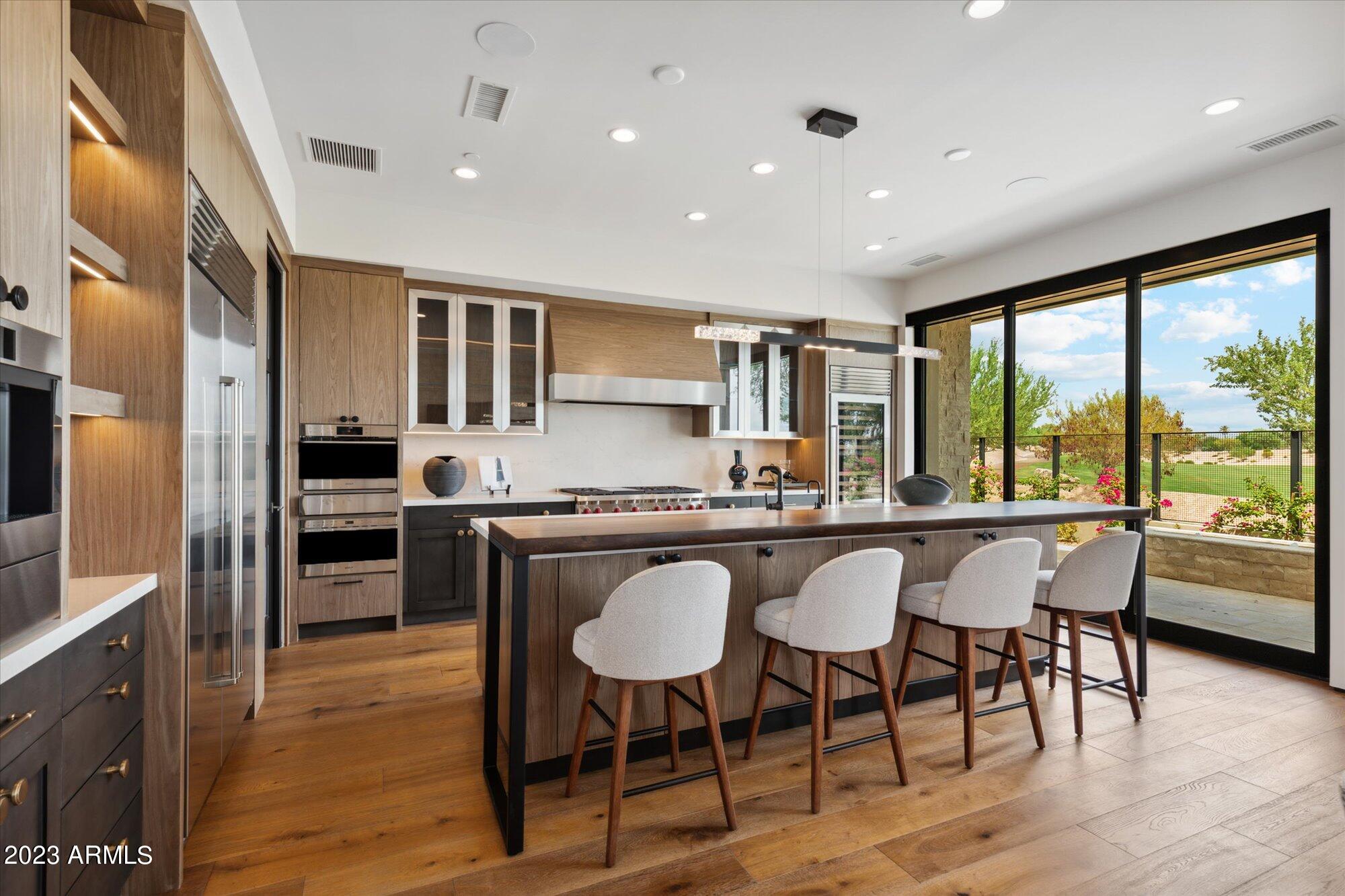 Welcome to an extraordinary brand-new residence crafted by the renowned Cullum Homes, where impeccable craftsmanship meets an unrivaled Scottsdale address. Nestled within a prestigious guard-gated community and perched along the 9th hole of The Phoenician Golf Course, this stunning two-story home delivers the refined desert lifestyle you've been searching for.

Step inside and discover a thoughtfully designed floor plan featuring the primary suite on the main level -- a true retreat offering privacy and convenience. The chef's kitchen is outfitted with premium Wolf stainless-steel appliances and a Sub-Zero side-by-side refrigerator and freezer, complemented by stylish eat-up bar seating perfect for casual gatherings. A formal dining area elevates your entertaining, while a private office provides a quiet space for focused work.

Upstairs, two additional generously sized guest bedrooms -- all en-suite -- surround an inviting loft area ideal for relaxation. Step onto the upstairs balcony and soak in incredible panoramic views that stretch across the lush fairways and dramatic desert landscape. A separate guest casita adds exceptional versatility for visitors or extended family.

Just steps from world-famous The Phoenician Resort and minutes from Arcadia Park, this location places world-class dining, shopping, and recreation at your fingertips. The surrounding environment blends natural Sonoran beauty with refined urban sophistication seamlessly.

This is more than a home -- it's an elevated lifestyle built with uncompromising quality in one of Scottsdale's most coveted enclaves.