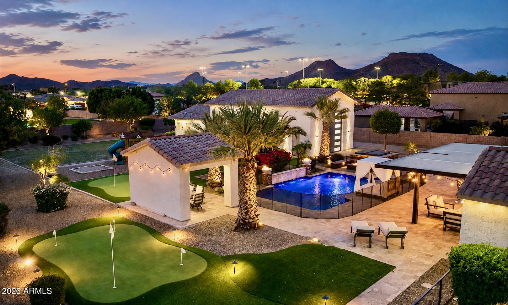 Tucked behind private gates on an expansive lot, this extraordinary custom estate blends luxury, recreation, and resort-style living into one unforgettable property. From the moment you arrive, the striking modern pivot entry door, circular driveway, dramatic front courtyard fireplace, and cascading water feature set the tone for a home designed to impress. Inside, the fully remodeled interior showcases designer finishes throughout, highlighted by an incredible chef's kitchen with a massive 72'' Sub-Zero-style refrigerator, custom pantry, and seamless indoor-outdoor flow through oversized custom sliders in both the family room and primary suite. Entertain effortlessly with a custom wet bar, Control4 smart home integration, surround sound, and multiple gathering spaces designed for both large-scale entertaining and everyday comfort. The backyard rivals a private resort, featuring a newly added pickleball and basketball court, multiple putting greens, over 3,000 square feet of premium artificial turf, lush real grass, mature fruit trees, outdoor kitchen, fire features, multiple ramadas, misting system, and a built-in Bullfrog spa. Car enthusiasts and hobbyists will appreciate the climate-controlled custom garages with lifts, epoxy floors, custom cabinetry, EV chargers, and extensive built-in storage. A detached guest house with full kitchen and laundry adds flexibility for guests, multigenerational living, or extended stays, while the extensive security system, RV amenities, permanent exterior lighting, fully paid solar, and countless custom upgrades make this property as functional as it is stunning. This is more than a home. It's a private luxury compound built for entertaining, relaxing, and living at the highest level.