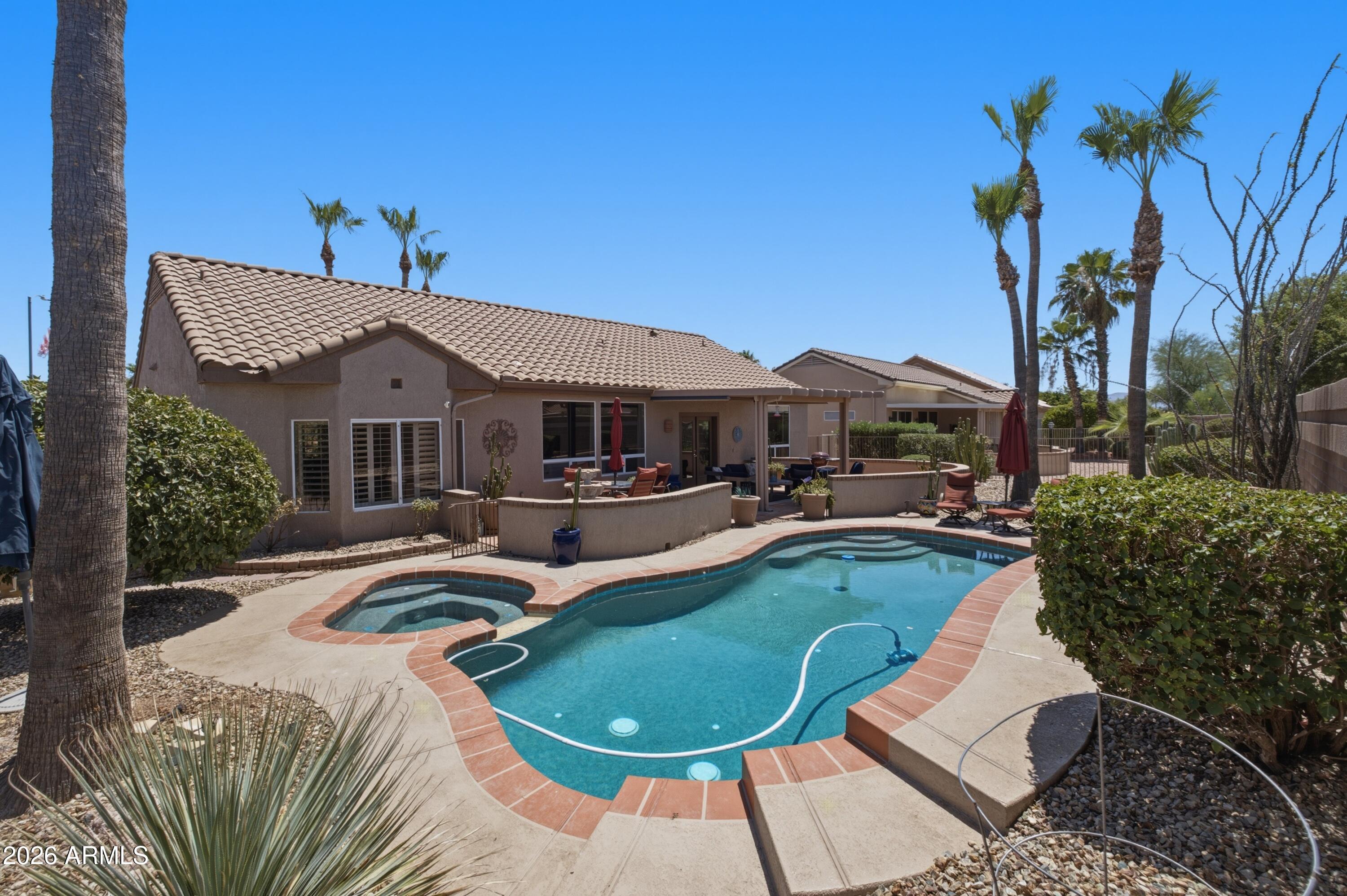 One-of-a-kind home in the heart of Sun City West's premier 55+ community! This beautifully updated 3-bedroom, 3-bath residence features a spacious den and a unique attached indoor/outdoor casita with both interior and exterior access--perfect for guests, extended family, or a private retreat. Updates include tile flooring, newer cabinetry, granite countertops, and fresh paint throughout. The split primary suite overlooks the sparkling pool and spa and offers a spacious walk-in shower. Designed for entertaining, the open floor plan features a breakfast nook, formal dining area, expansive great room, cozy fireplace, and media space ideal for gatherings or relaxing evenings at home. Exceptional value for a home of this caliber!