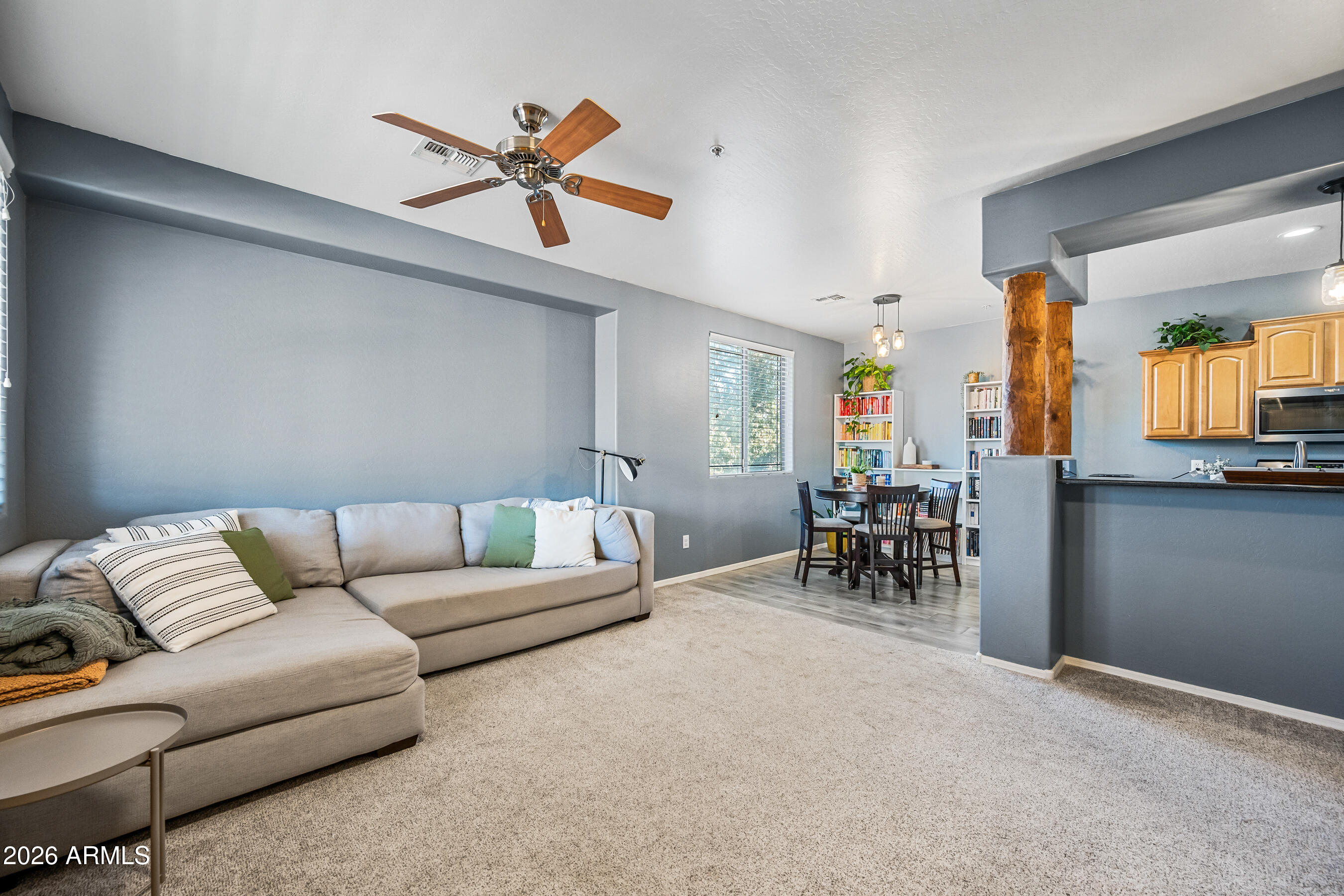 Welcome home to this beautifully maintained 1,180 sq ft, 2-bedroom, 2-bath Chandler gem offering comfort, charm, and thoughtful upgrades throughout! A private covered patio welcomes you into the inviting interior featuring newer gray carpet and plank tile flooring. The great room and kitchen are both stylish and functional featuring a breakfast eating nook,  peninsula with breakfast bar, rustic wood beams, granite countertops, rich walnut cabinetry, stainless steel appliances, built-in microwave, electric range, and pantry--perfect for everyday living or entertaining. The spacious primary suite offers tall ceilings, a ceiling fan, walk-in closet, and a well-appointed ensuite bath with soaking tub, separate shower with glass doors, updated lighting and framed vanity mirror. A rare bonus for condo living, this unit includes a detached private garage complete with ceiling storage racks and additional side storage. HVAC is 5 years old and the Water Heater is 2 years old.  Enjoy resort-style community amenities including a pool and spa, fitness center, playgrounds, and scenic walking and biking paths. HOA covers water, sewer, and trash, making for easy, low-maintenance living in a fantastic Chandler location!!