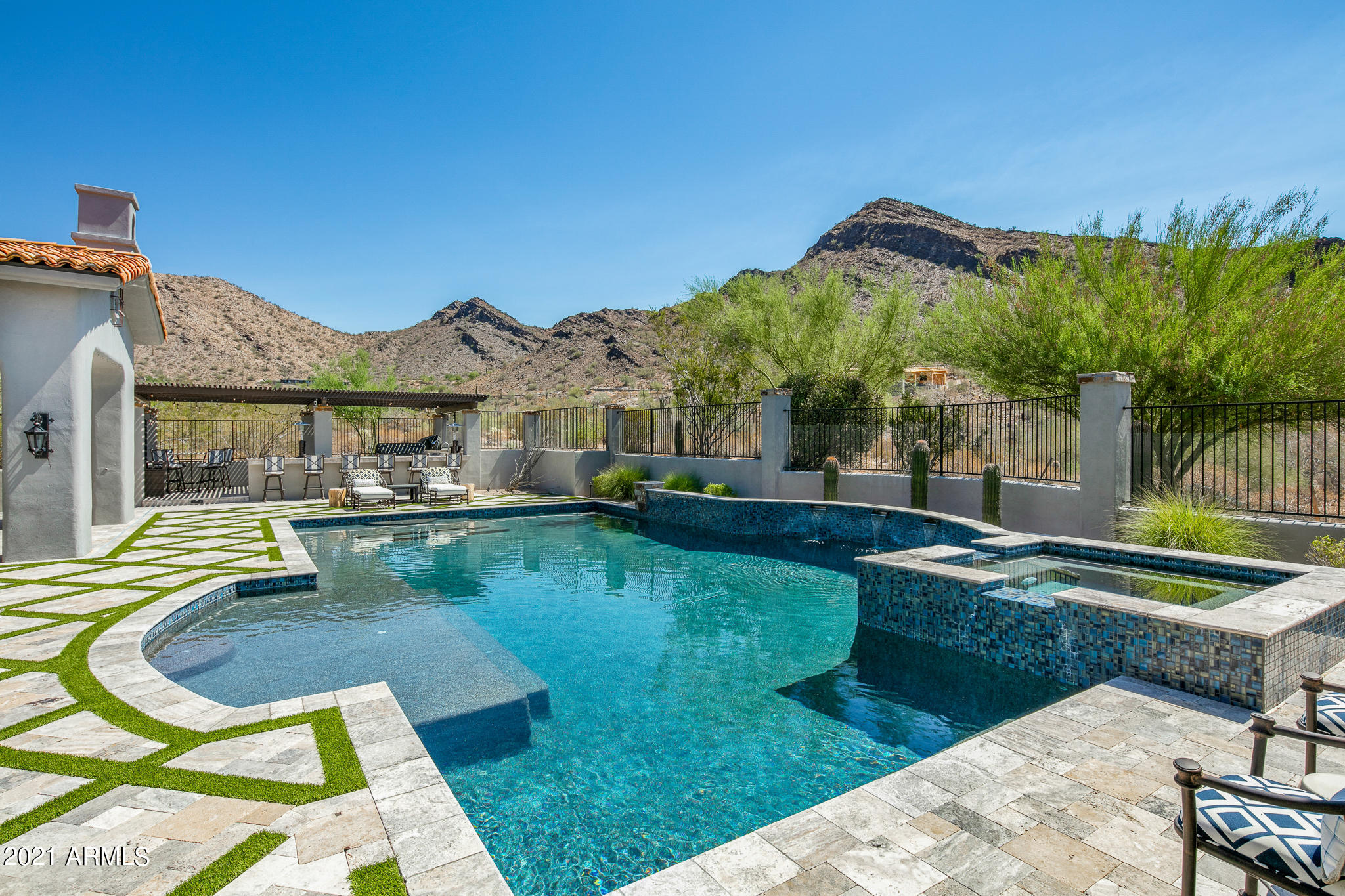 Nestled into the McDowell Mountains, this custom home is located in the exclusive guard gated community of DC Ranch. Offering luxurious finishes and an open concept floorplan, this transitional style home is perfectly situated to soak up the year-round Arizona sunshine and experience superior mountain views. Sun-drenched great room boasts custom fireplace mantel, flanked by two sets of disappearing glass doors for seamless enjoyment of the backyard incl. glass tile pool. Gourmet kitchen features high-end appliances, dual dishwashers and Dutch door to the outdoor dining room warmed by gas fireplace and adjacent to outdoor kitchen. Incredible master suite offers cozy fireplace to warm the morning chill & beautiful ensuite bathroom. Wake up to enjoy breathtaking mountain views every day! Master suite also offers a private outdoor shower & clawed foot bathtub because Arizona weather deserves to be enjoyed at any chance! Ensuite guest bedroom upstairs features sitting room, well appointed bathroom and private balcony. Oversized theatre and game room upstairs features kitchenette, projector, and a wall of windows overlooking the mountains with French doors leading out to the balcony. Need to run back downstairs from the game room in a hurry? Take the wrought iron spiral staircase from this balcony and re-join the party. Secondary upstairs bonus room is a great workout room or home office. Three additional guest bedrooms located on the main level includes one ensuite, and all are outfitted with custom closets and desks. Attached guest house is accessed via the charming front courtyard complete with gas fireplace and offers kitchenette and private entrance. Last but not least, secure dog run offers synthetic grass and protective measures on the block wall to keep furry family members safe no matter what. 

Residents of DC Ranch enjoy access to two community centers featuring pool, adventure play park, splash pad, sport courts, fitness center, locker rooms, as well as community activities. Well maintained walking paths meander throughout the community connecting the various neighborhood parks together for an enjoyable stroll any time of day. 

The Country Club at DC Ranch offers a range of golf and social memberships for residents and non-residents alike (membership not required for purchase). Members enjoy the serene estate-like Hacienda Clubhouse and its many amenities including a range of restaurants, private golf 18 hole golf course, a new par 3, nine-hole short course, comprehensive tennis program, new fitness and performance center, men's & women's locker rooms, both lap and play pools including a multitude of loungers and spectacular mountain views.

Do not miss the 3D Walkthrough of this home in the photos tab! Simply click the "play" button in the lower left-hand corner to be taken on a guided tour through the home.