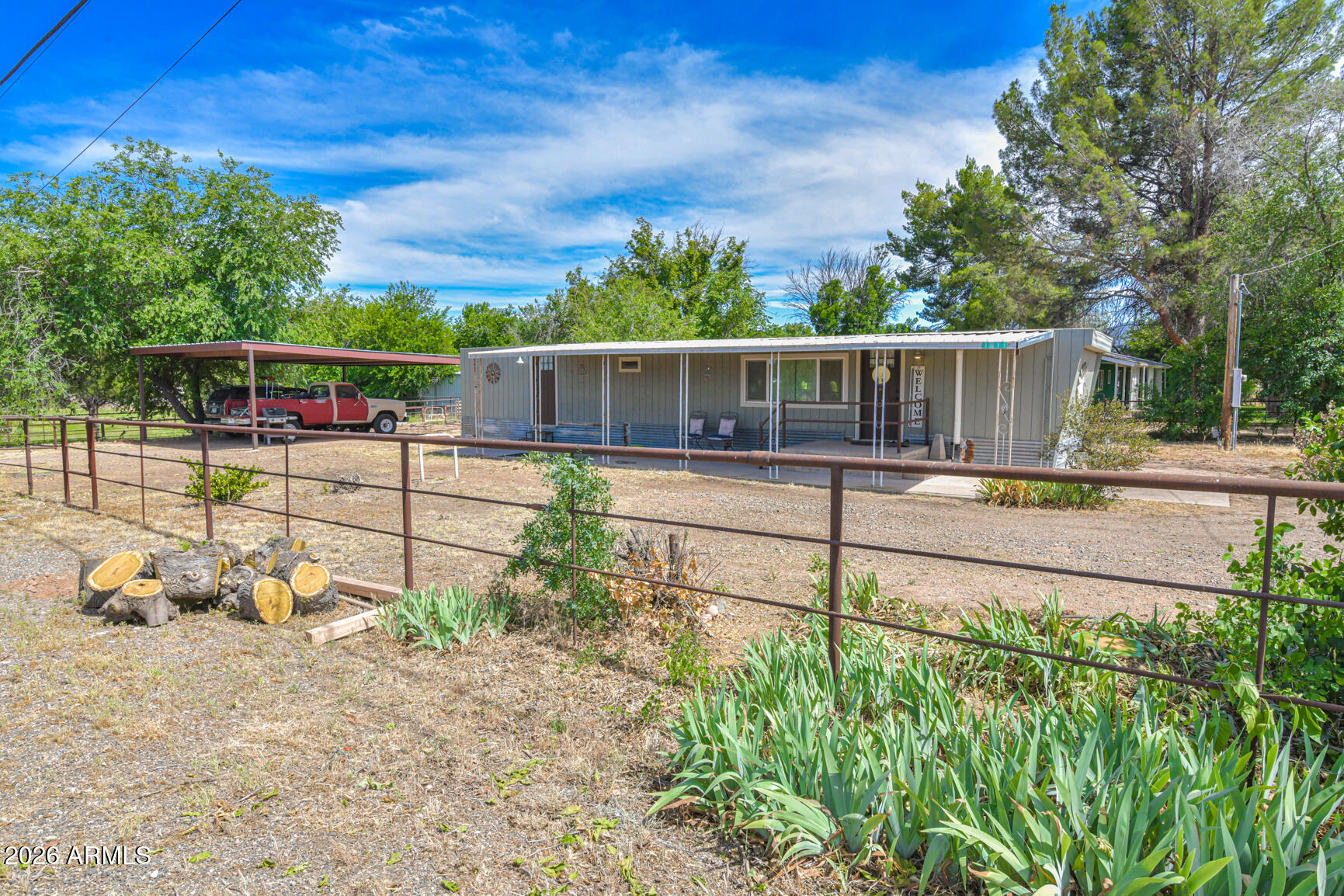 Completely remodeled from the studs, this charming 2-bedroom, 1-bath home on 1.09 acres w/paved access offers fully fenced property in Camp Verde. Virtually every component has been updated, including Insulation, Electrical, Lighting, PEX plumbing, Windows, Flooring, Mini-split Heating and Cooling Systems, & a full remodeled bathroom w/ unique barn wood cabinets- so much character. The kitchen features soft-close cabinetry, granite countertops, stainless steel appliances including dishwasher. The refrigerator, washer, & dryer are included, making this home truly move-in ready. Outside, you'll find a pasture w/ditch irrigation, sprinkler system, pipe rail horse & cattle fencing, vehicle access gates on both sides of property, RV parking, a large 2-car carport spacious storage shed, and additional shelter ideal for a small farm or livestock. The quality and functionality of the fencing and gates are difficult to fully appreciate in photos and must be seen in person. Thoughtful planning and attention to detail make this property exceptionally well-suited for animals, hobby farming, equipment storage, and outdoor living.
Served by city water and all-electric utilities, this property offers the perfect blend of updated living and rural versatility with room to enjoy the Camp Verde lifestyle.