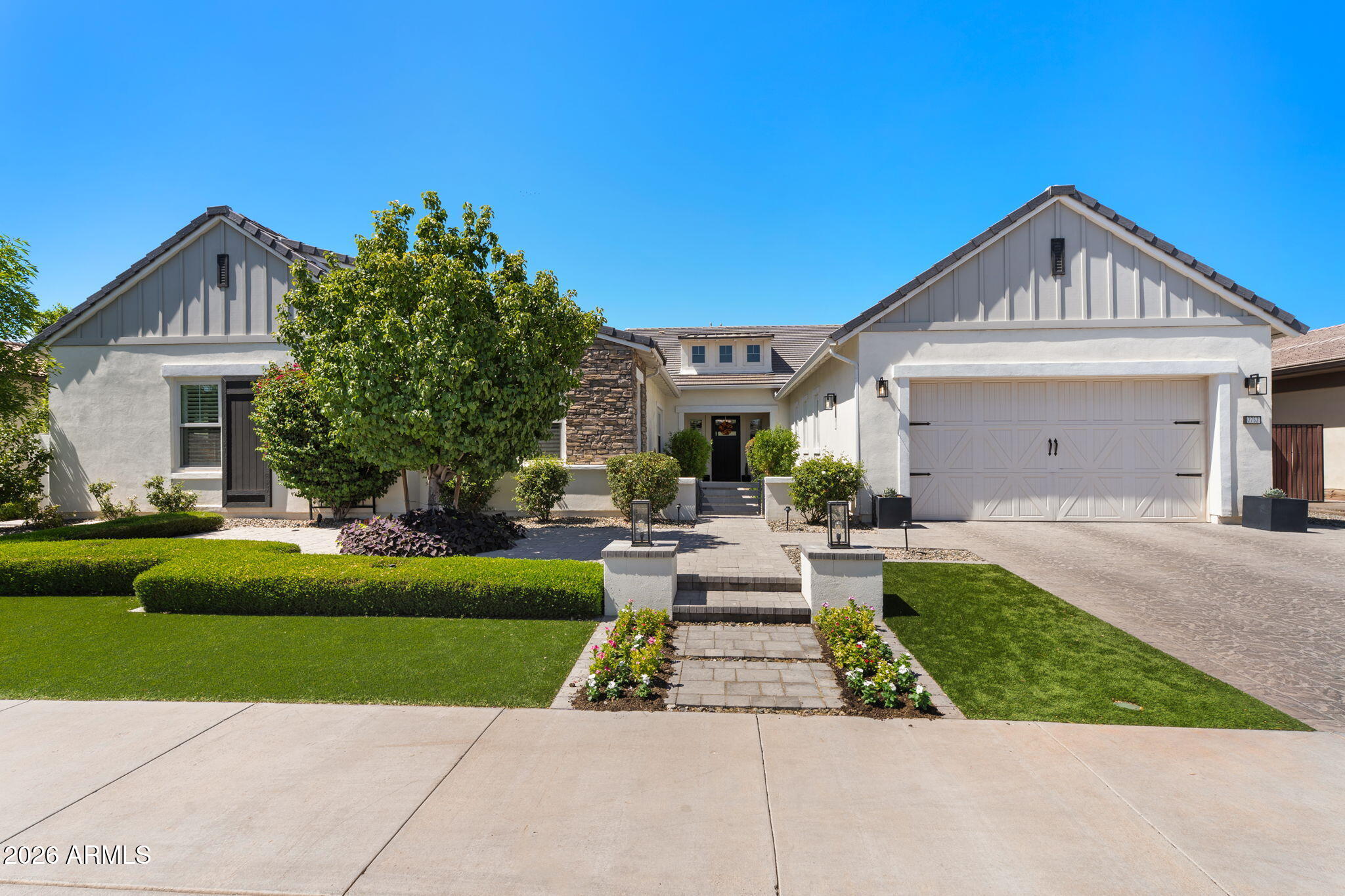 Set within the prestigious gated lake community of Somerset at Belmont, this exceptional single-level estate redefines modern luxury living. Built in 2019 and spanning over 4,200 square feet, the residence masterfully blends sophisticated design, resort-inspired amenities, and effortless indoor-outdoor living.

From the moment you arrive, meticulously curated landscaping and architectural details set the tone for what awaits inside. Thoughtfully designed for both grand entertaining and everyday comfort, the home offers 5 spacious bedrooms, 4.5 bathrooms, 4 car garage, a private executive office, and expansive living spaces filled with natural light and refined finishes. At the heart of the home, the chef's kitchen is complemented by an oversized walk-in pantry, wine refrigeration, and seamless flow into the main gathering areas. Plantation shutters, custom built-ins, a gas fireplace, and designer accent features create an atmosphere of understated elegance throughout.

Step outside to a private resort unlike anything else on the market. The backyard has been transformed into an extraordinary retreat featuring a sparkling pool and spa, a fully equipped pool house complete with bathroom and shower, an outdoor kitchen and grilling station, misting system, putting green, splash pad, and in-ground trampoline. Every detail has been carefully considered to create a setting that is equally suited for lavish entertaining or quiet evenings under the Arizona sky.

Additional luxury amenities include a tandem four-car garage with EV charging capability, mudroom with custom cabinetry, laundry room with sink and extensive storage, tankless water heating system with recirculation technology, water softener, and numerous energy-efficient upgrades throughout.

Rarely does a home combine this level of craftsmanship, functionality, and resort-caliber outdoor living within one of Gilbert's most coveted master-planned communities. This is more than a residence--it is a lifestyle defined by elegance, comfort, and distinction.