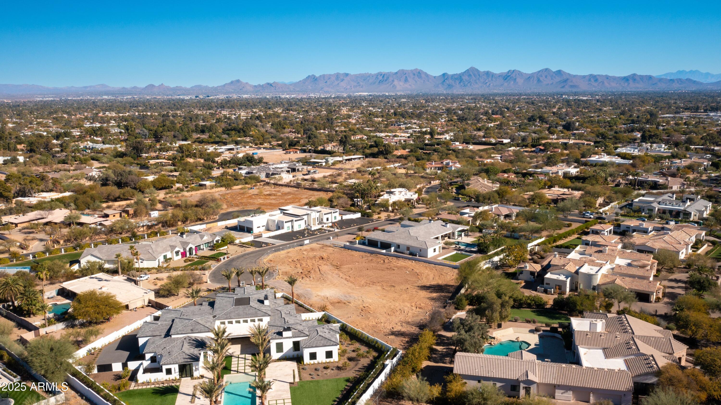 This prime one-acre Paradise Valley lot offers expansive 360-degree views of Mummy Mountain, the McDowell Mountain Range, and the Phoenix Mountains Preserve. Located on a private cul-de-sac and surrounded by beautiful new builds, the lot has been meticulously cleared and prepared—no hillside zoning required—so it's ready to dig and build your dream home. With all the heavy lifting already done, including preliminary plans, this is an exceptional opportunity in the coveted 3 C's school district, just minutes from PVCC and Arizona's top resorts, golf courses, dining, and shopping.