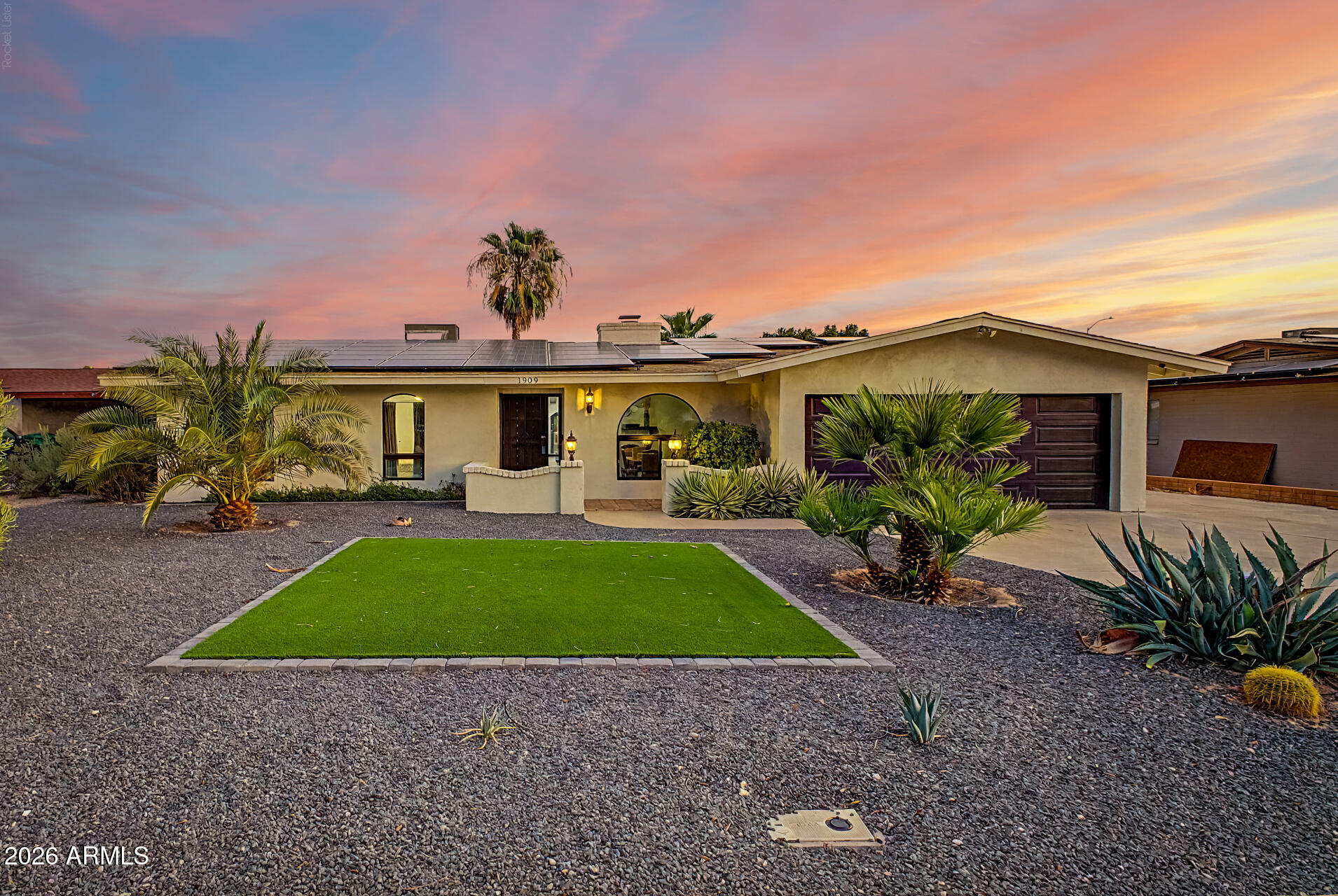 Whether you're searching for your primary residence, a second home, or a proven short-term rental investment, this beautifully updated Mesa home offers exceptional flexibility, modern upgrades, and resort-style outdoor living. Previously operated as a successful Airbnb, this property is move-in ready and offers outstanding potential as a vacation rental or owner-occupied home. Situated on a premium north/south-facing cul-de-sac lot, this 4-bedroom, 3-bathroom home has been extensively updated with a new roof (2022), new water heater (2022), and newer HVAC systems (2023 & 2026), providing long-term value and peace of mind. Inside, you'll find luxury vinyl plank flooring throughout, upgraded 4-inch baseboards, vaulted ceilings with exposed wood beams, and a stunning two-way wood-burning fireplace that creates a warm and inviting atmosphere. New door hardware, lighting, ceiling fans, and fixtures give the home a fresh, modern feel. The remodeled chef's kitchen is designed for entertaining and everyday living, featuring a large island with breakfast bar seating, quartz countertops, white shaker cabinetry with hardware, pantry storage, and stainless-steel appliances. The spacious laundry room includes additional cabinetry and a utility sink for added convenience. The private primary suite offers direct access to the backyard and a fully remodeled en-suite bathroom with a custom tile walk-in shower, modern vanity, updated mirrors, and designer fixtures. A secondary bathroom has also been beautifully renovated with a new vanity, updated lighting, mirrors, fixtures, and a tile-surround tub and shower. Step outside into your own backyard resort, complete with a heated diving pool, built-in BBQ island, putting green, separate gazebo seating area, mature citrus trees, storage shed, and multiple spaces for entertaining, relaxing, or hosting guests year-round. Ideally located in Mesa near Cactus League Spring Training stadiums, golf courses, shopping, dining, entertainment, and convenient freeway access, this home offers the Arizona lifestyle buyers are looking for while presenting an outstanding opportunity for those interested in a turnkey vacation rental or income-producing property. If you're searching for a home with a heated pool, remodeled kitchen, updated bathrooms, cul-de-sac lot, Airbnb potential, luxury upgrades, and an unbeatable Mesa location, this property checks every box.