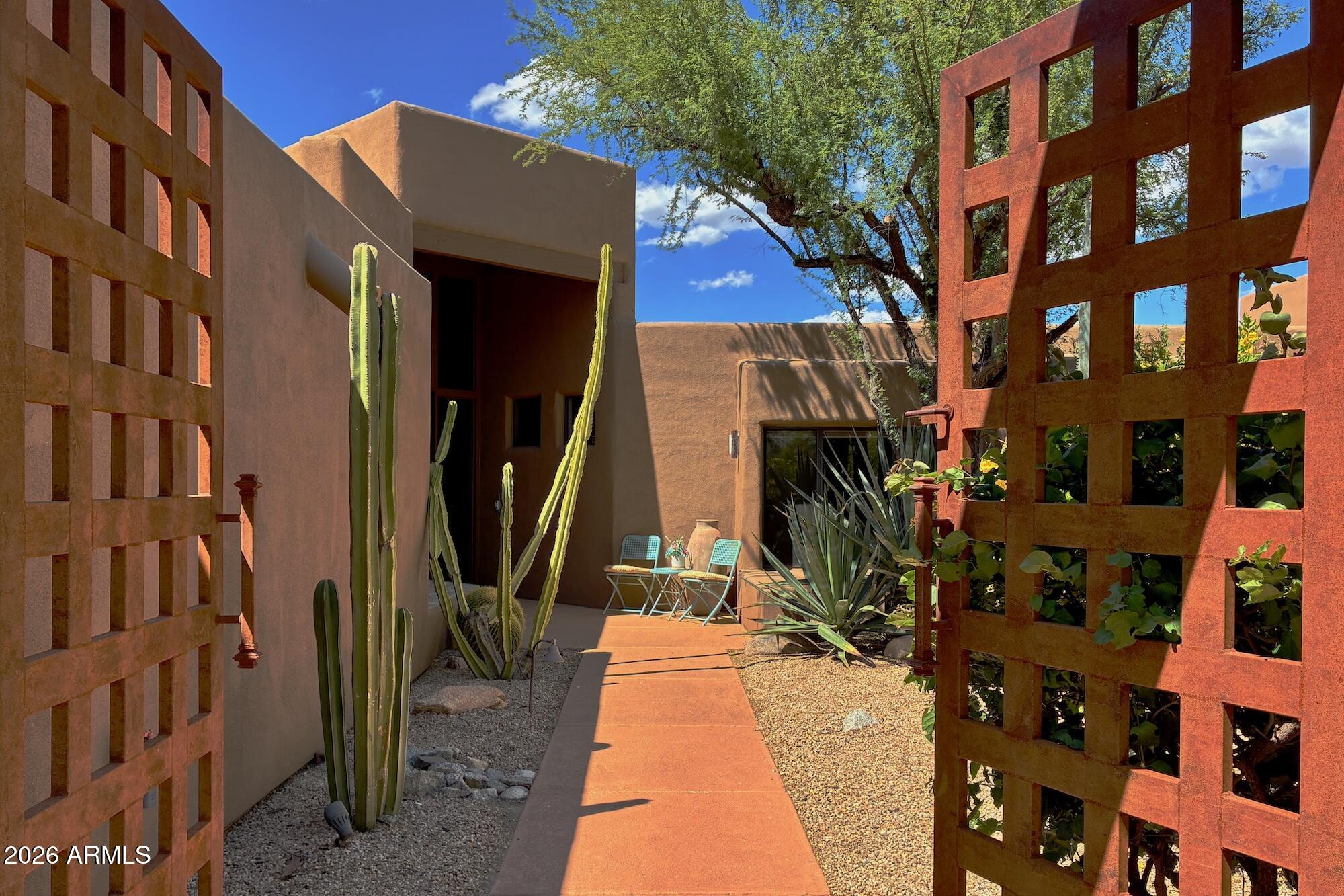 A rare opportunity to own one of the few all en suite 3-bedroom patio homes located in the SkyRanch at Carefree gated community. The third bedroom has exterior access from the patio. Extensively remodeled 2019-2023 including all kitchen and baths, quartz countertops, interior/exterior paint and stucco, HOA mandated exposed metal garage door and gates, updated LED lighting, and all new hardware. The north facing covered patio was remodeled to include AZ cool decking and a gas/wood fired masonry pizza oven. It features a vista that includes the airport runway at distance with an unobstructed view of Continental Mountain as a backdrop. Community amenities include a heated swimming pool and spa, tennis court, dog park and new asphalt roads updated 2025. There is nothing left to do but move in.