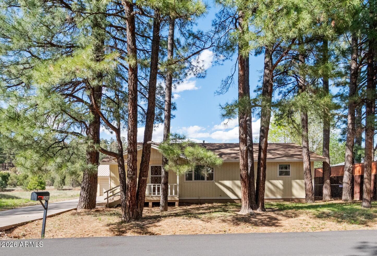 Welcome to this beautiful mountain home surrounded by tall pines and whispering winds! A new roof and new appliances make this home the perfect move-in ready home. This 2 bedroom 2 bathroom home checks all the boxes with the potential to make it your permanent family home, a vacation getaway or even the potential for residual income as a short-term rental! Step inside to an updated floorplan with modern finishes, abundant storage, and a functional layout perfect for everyday living or entertaining. The open floor plan flows seamlessly into warm, inviting living spaces filled with natural light, creating a cozy atmosphere you'll love coming home to. Enjoy the serenity of the surrounding pines while being just minutes from town for shopping, dining, and schools.