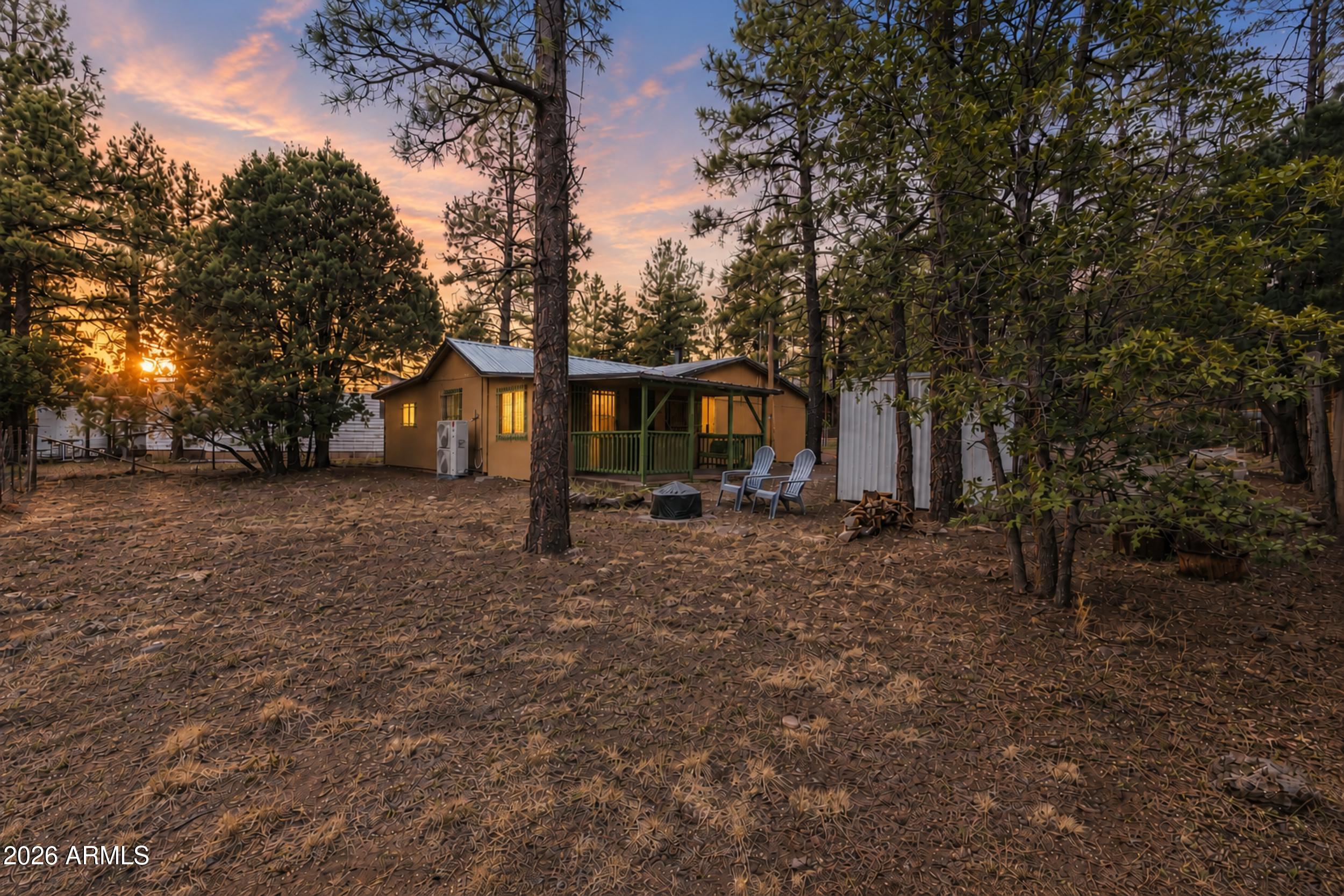 Escape to the cool mountain air with this fully furnished cabin in the pines, ready for you to move in and start making memories! Featuring 3 bedrooms and 1 bathroom, this cozy mountain retreat offers a welcoming living and dining room combination centered around a warm wood-burning stove - the perfect place to relax after a day of exploring the outdoors.
The kitchen is equipped with an electric range, dishwasher, and breakfast bar, offering both convenience and functionality. A spacious utility room provides endless possibilities for additional storage, a hobby space, home office, or a flex space to fit your lifestyle.
The home's versatile third bedroom offers flexibility to fit your needs and is ideal as a guest room, bunk room, office, or creative space. (Please note this room... does not include a closet.) Step outside to enjoy the peaceful mountain setting from the covered patio with a charming bench swing. The fully fenced lot offers added privacy and room for pets or outdoor activities, while the durable metal roof provides lasting peace of mind. Whether you're searching for a full-time residence, a weekend getaway, or a turnkey vacation rental opportunity, this fully furnished cabin combines rustic charm, comfort, and convenience in a beautiful setting among the pines. Simply bring your suitcase and start enjoying mountain living!