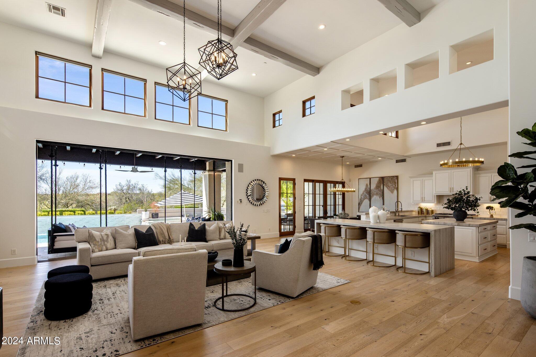 Stunning remodeled single level custom home backing to an expansive desert wash provides one of the most secluded residences in Silverleaf Arcadia. This fantastic open floorplan is filled with an abundance of natural light boasting a large Great Room that is open to the Kitchen, Bar, and Breakfast Nook.  5 bedroom suites including the Guest House, 6 baths, Office, large Game/Media room, Exercise room, formal Dining Room, Wine room, Wet Bar, and a 3 1/2 car oversized Garage.  Automated pocket door system connects the interior with the outdoor living spaces and frames the amazing open views from the rear of home with total privacy & beautiful sunsets. $450k of outdoor improvements just completed (pool, landscape, firepit, fountains, putting green,BBQ, etc) + $65k new variable speed AC units Additional improvements: Primary bathroom completely remodeled including addition of 2nd water closet, all new closets by California Closets including $30k for the Primary closet, addition of Primary suite washer & dryer, wide plank white oak wood flooring throughout including all bedrooms, new tile flooring at all bathrooms, bar, and laundry, new lighting fixtures, all new countertops, bathroom cabinetry, new LED recessed can lights, ceiling speakers, Control 4 automation, automated window shades, new interior doors, hardware, and baseboards, all new plumbing fixtures, all shower tile surrounds & glass enclosures, mirrors, new paint, new laundry equipment, and new wine room compressor.
The home is light, bright, and refined throughout with a very functional floorplan and has the rooms and spaces that most are looking for in a comfortable livable layout.
The home sits at the end of the street off of a culdesac with plenty of guest parking curbside or on the expansive driveway and guest parking could be expanded if needed.  As you enter the home and look through the Great room over the pool out to the expansive open space area behind this property you get an immediate feeling of solitude and complete privacy as if you live on 50 acres of land with no one around you.  
This is a great opportunity to live on one of the best lots in the Guard Gated Silverleaf Arcadia community in a single level remodeled home with well designed beautiful finishes.
The home may be purchased furnished on separate bill of sale.

Silverleaf, located in North Scottsdale, Arizona, is a prestigious guard gated community known for its luxurious estates, exclusive golf courses, private Club and stunning desert landscapes. The Tom Weiskopf-designed Silverleaf Golf Course is a highlight for golf enthusiasts. With a blend of Spanish and Mediterranean-inspired architecture, the community offers a high standard of living, including upscale amenities like spas, fine dining, and exclusive shopping. Residents enjoy a harmonious balance between modern luxury and the natural beauty of the desert environment, making Silverleaf a sought-after destination for those seeking an exceptional lifestyle in North Scottsdale.