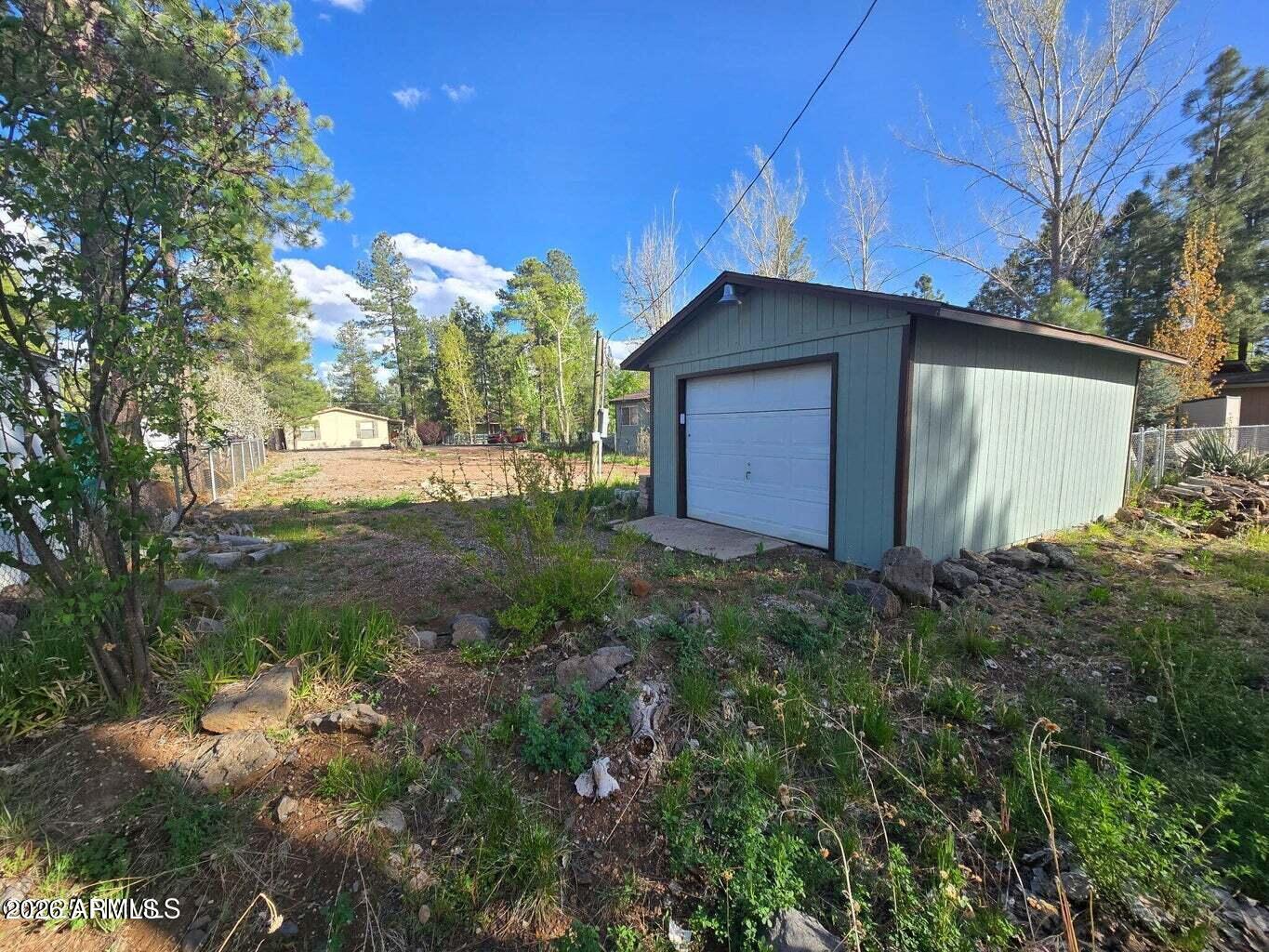 Rare find in Munds Park, far enough to be away from the noise but close enough to still be in the mix, located in a cul-de-sac on Poco Place. Seller will consider Owner Carry financing. Vacant land was once home to a 1986 Whitter 25 x 52 manufactured home. Home was removed and land is waiting for a new home. Land includes 1 car detached garage with new roof. Seller completed survey 7.25 Established electric, water, and sanitary remain - buyer to confirm any cost with re-connection of utilities lines to home with private vendors and/or with utility companies. Great opportunity for a home in Munds Park!